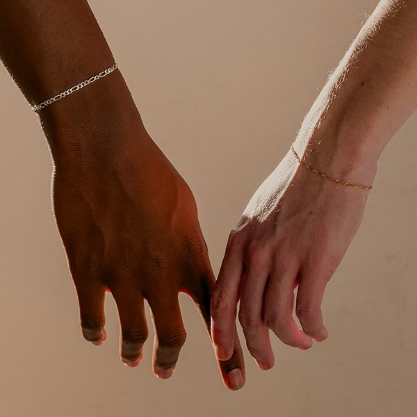 permanent jewelry on pair of hands