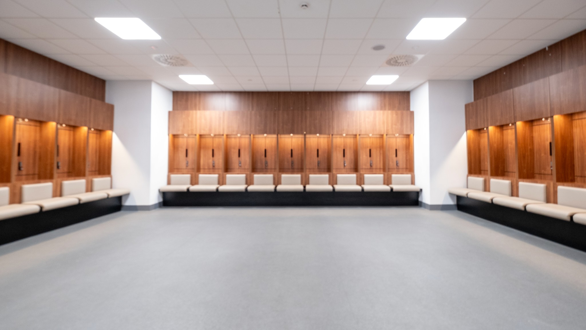 Two classic volkswagen beetles, one green, one cream.