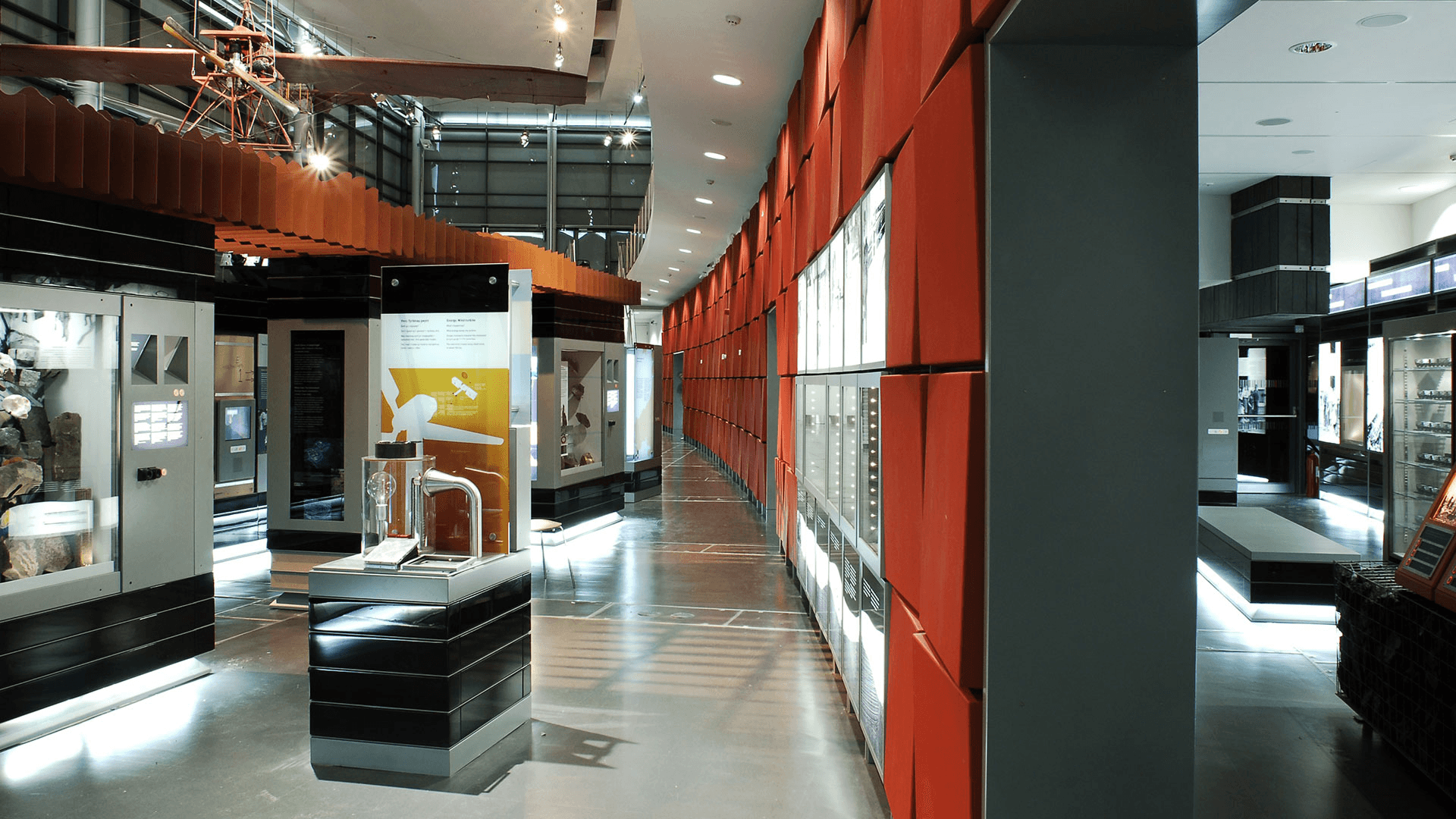 A BBC news studio setup featuring a central desk, bright lighting, and large screens in the background.
