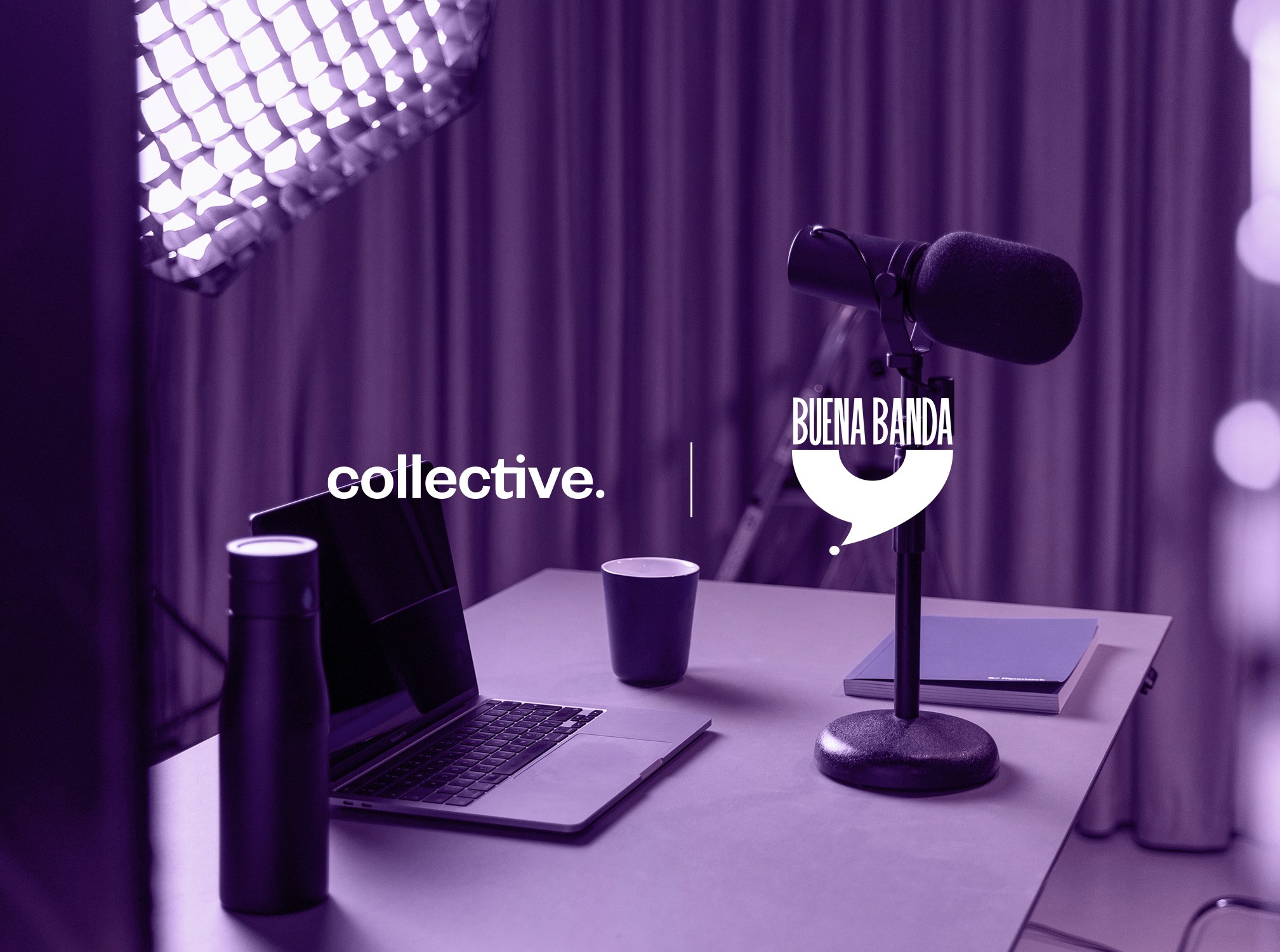 A modern office workspace with a wooden desk, laptop, notebooks, and potted plants by a bright window