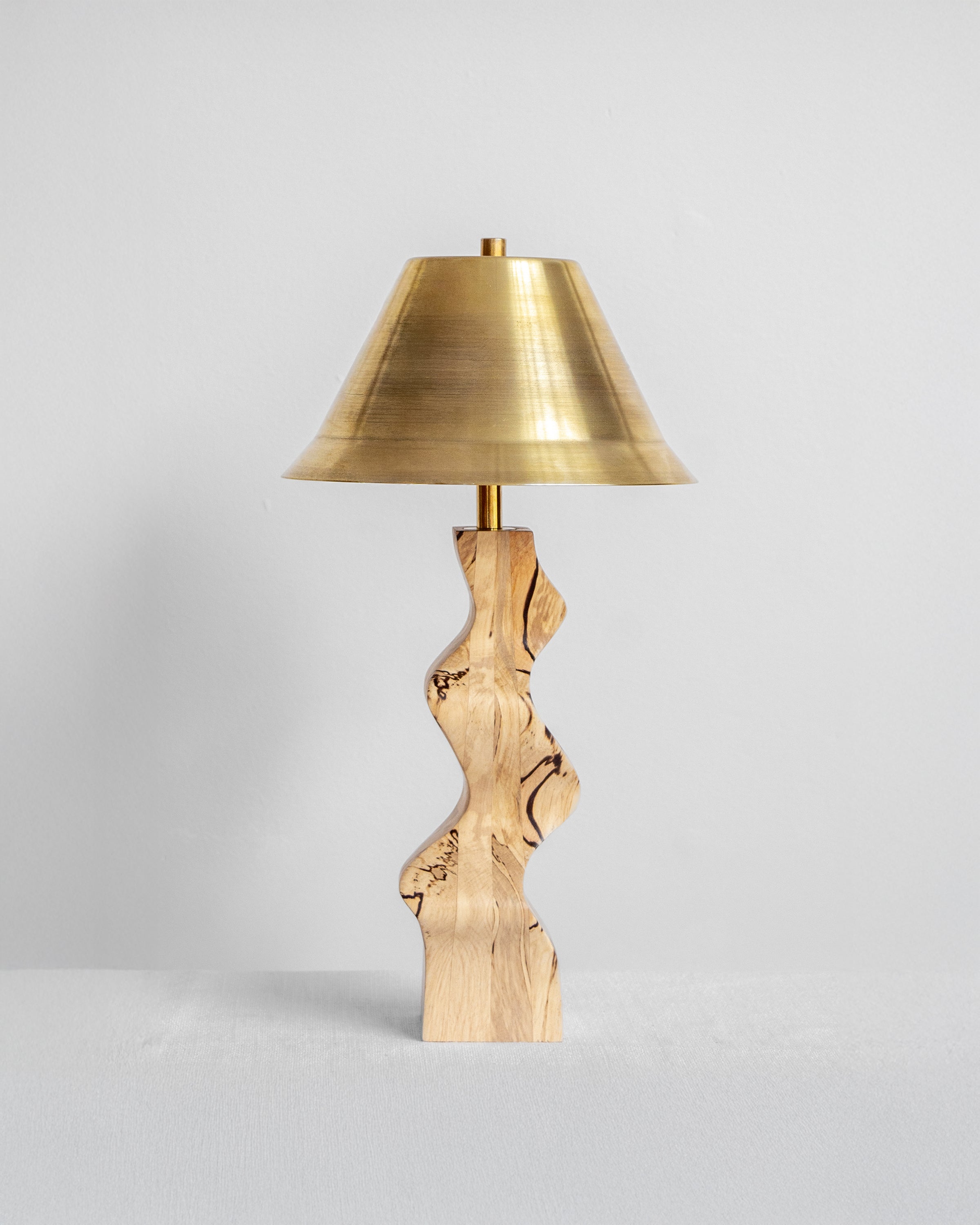 Rippled Desk Lamp with Spalted base and Brass shade on a light grey background with UK, EU and US/CA wiring available on white background Wilkinson & Rivera