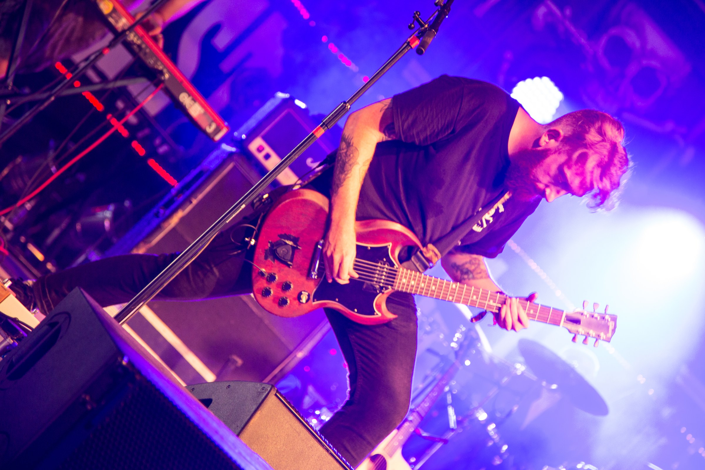 EVENTS · Live guitar under purple stage lights.