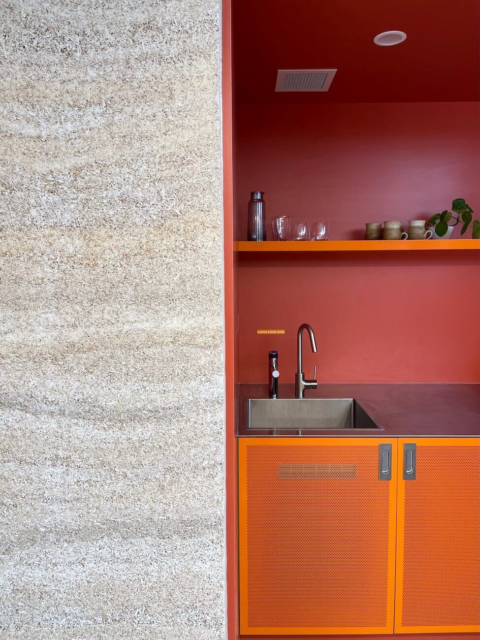 A wall design showing a sink and clean surface 