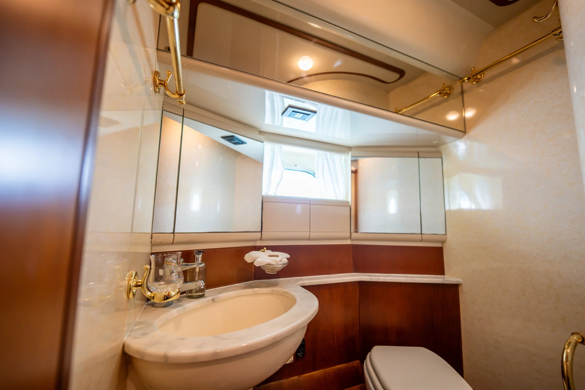 White Rock 36 speedboat with captain at helm cruising calm blue waters near Paros coastline with hills in background.