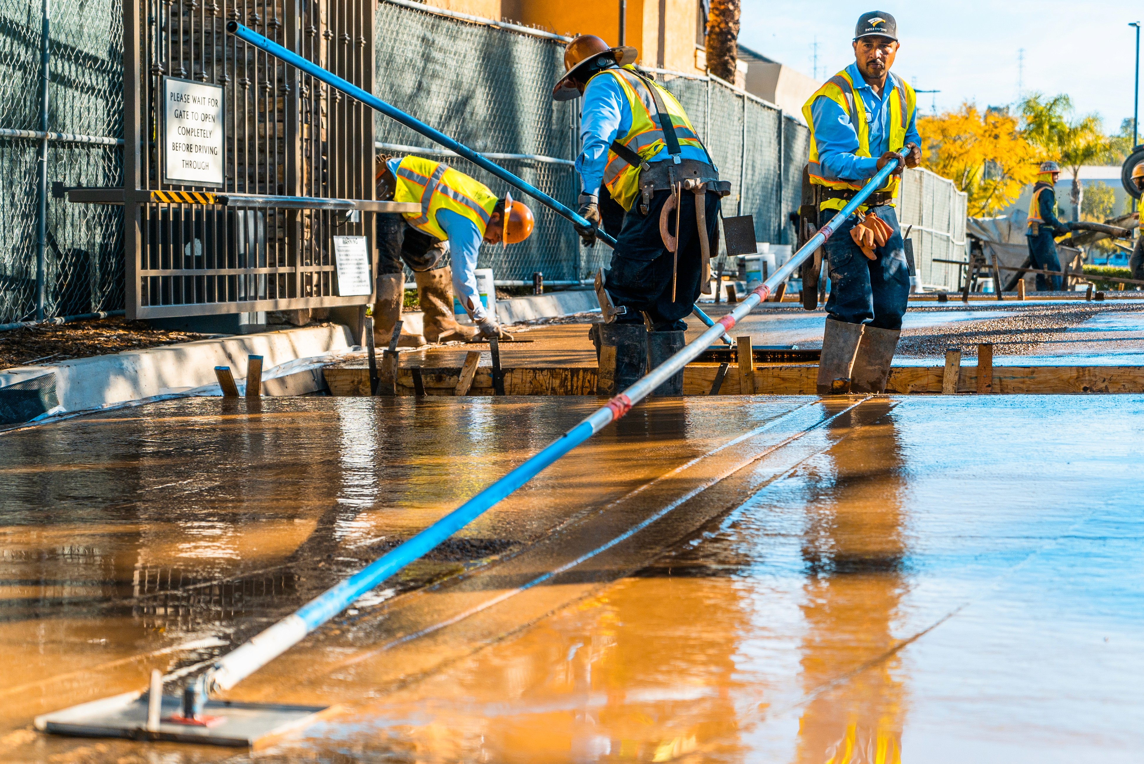 Concrete finishers floating concrete on a project