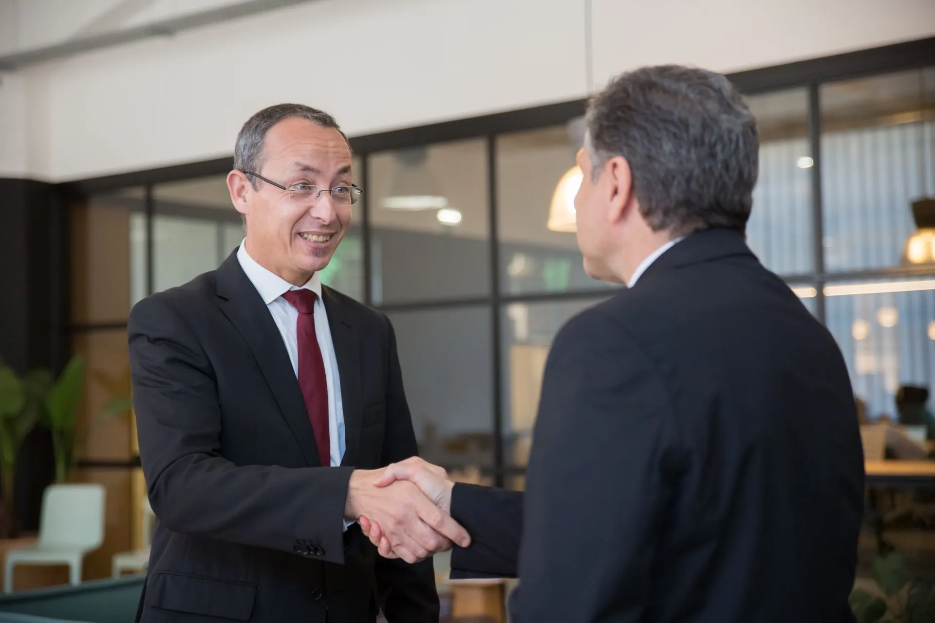 Two businessmen shaking hands in an office