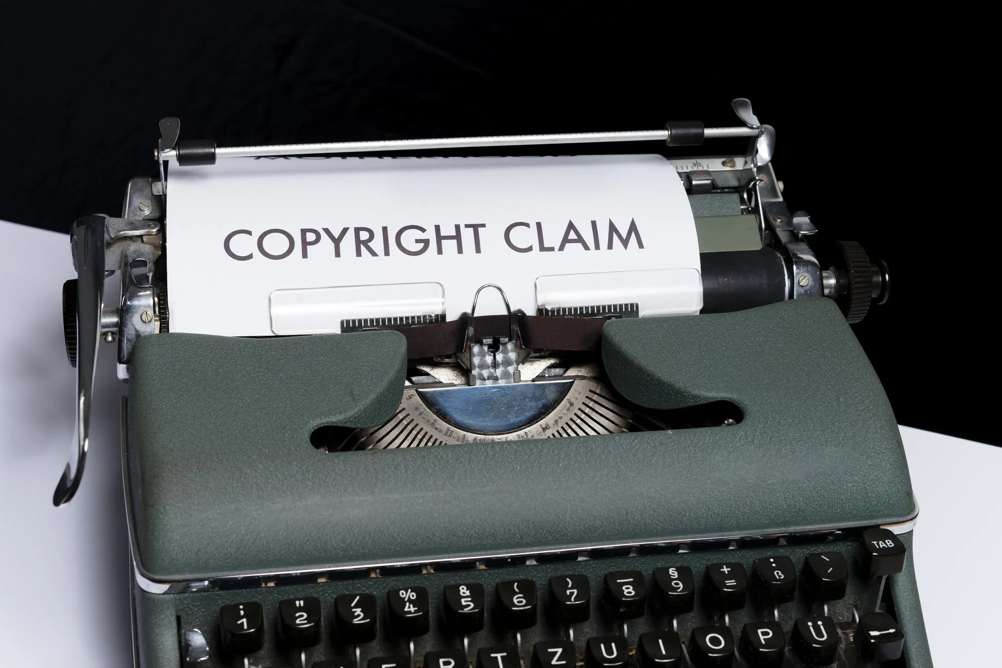 Antique typewriter with a piece of paper in it that states, "COPYRIGHT CLAIM"