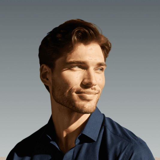 Portrait of a man in a blue shirt looking away under strong lighting