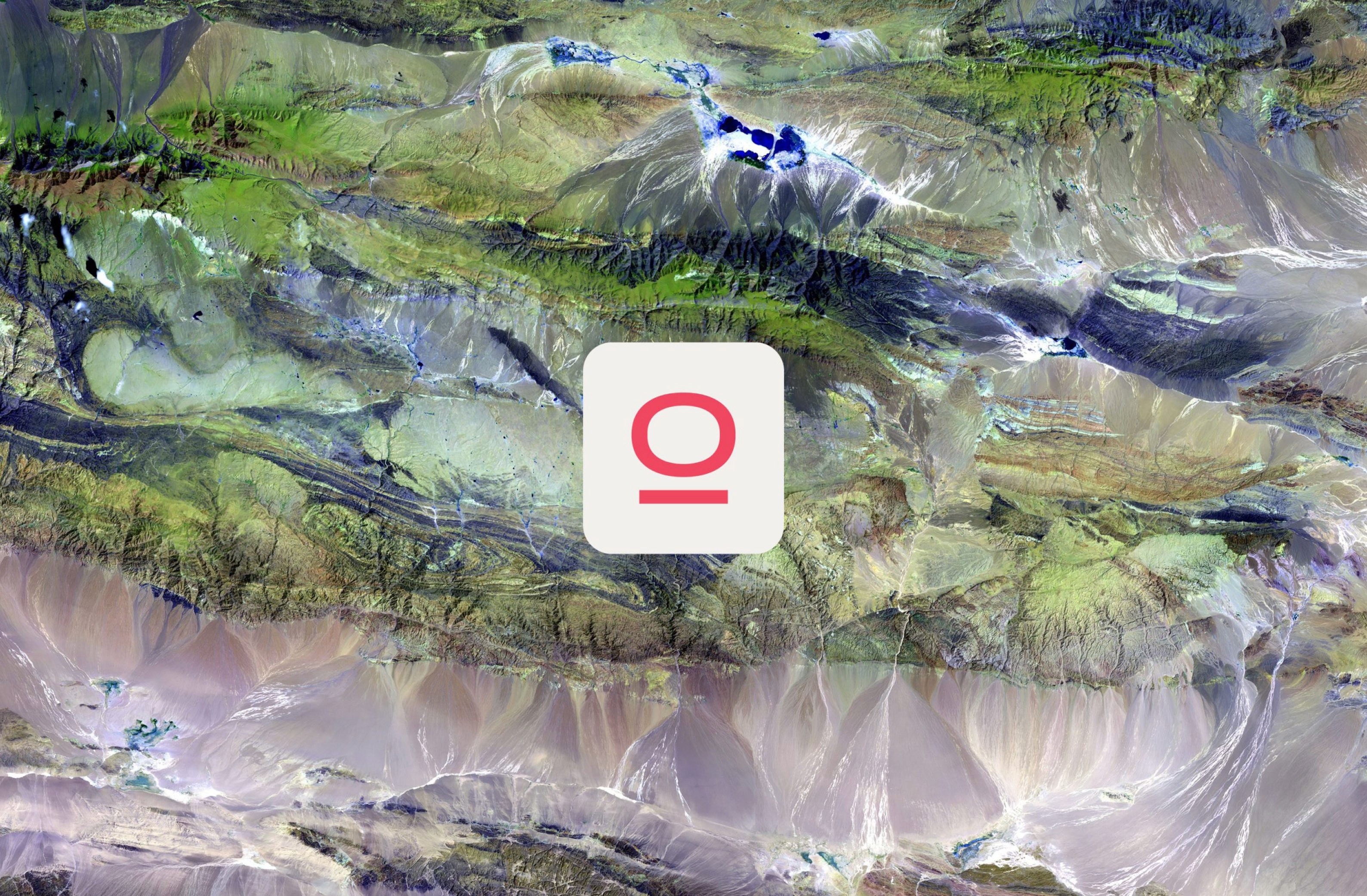 Stunning aerial landscape featuring vibrant colors and textures of mountains and valleys, with a minimalist logo prominently displayed.
