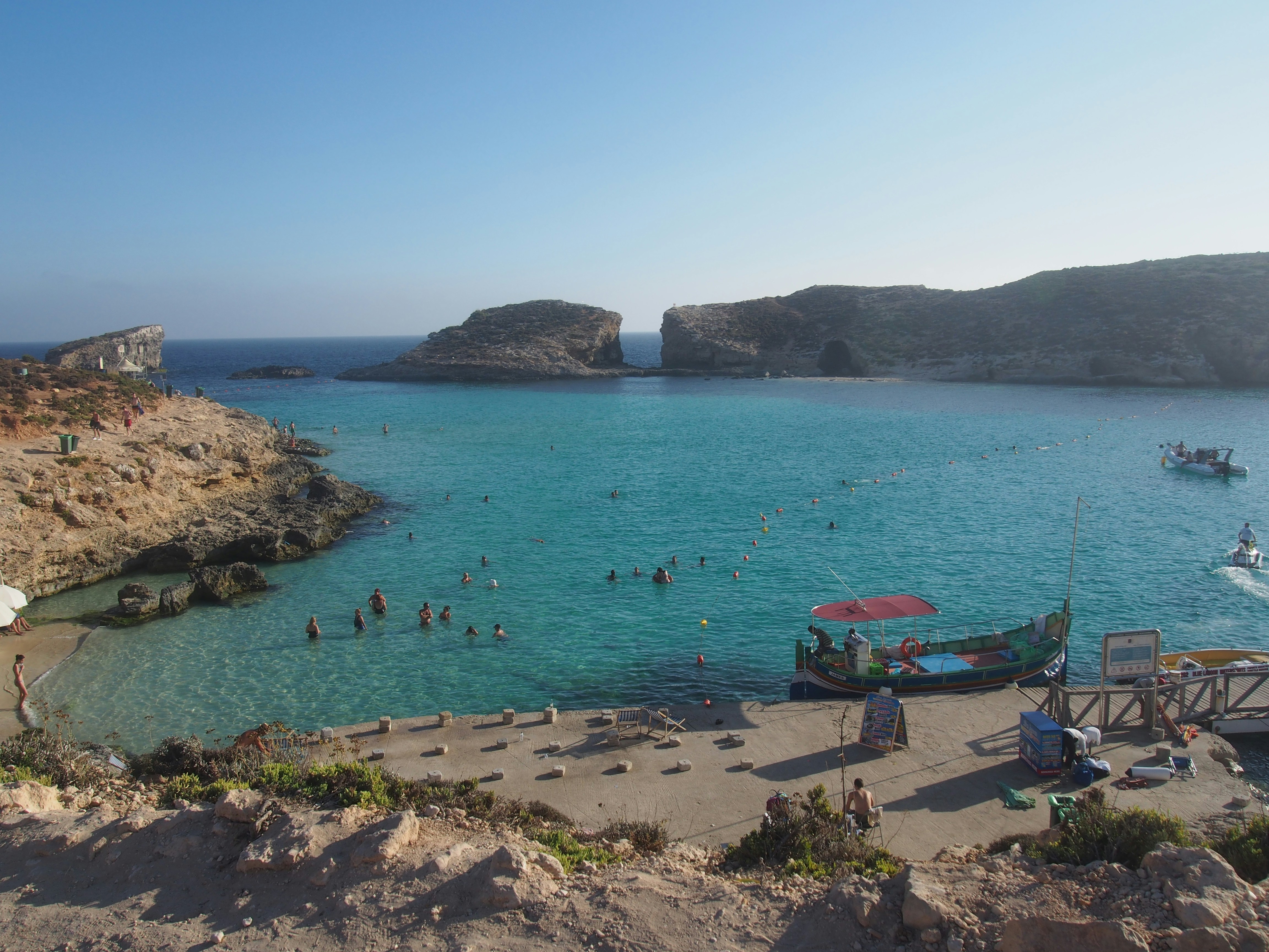 a beach with people swimming in it