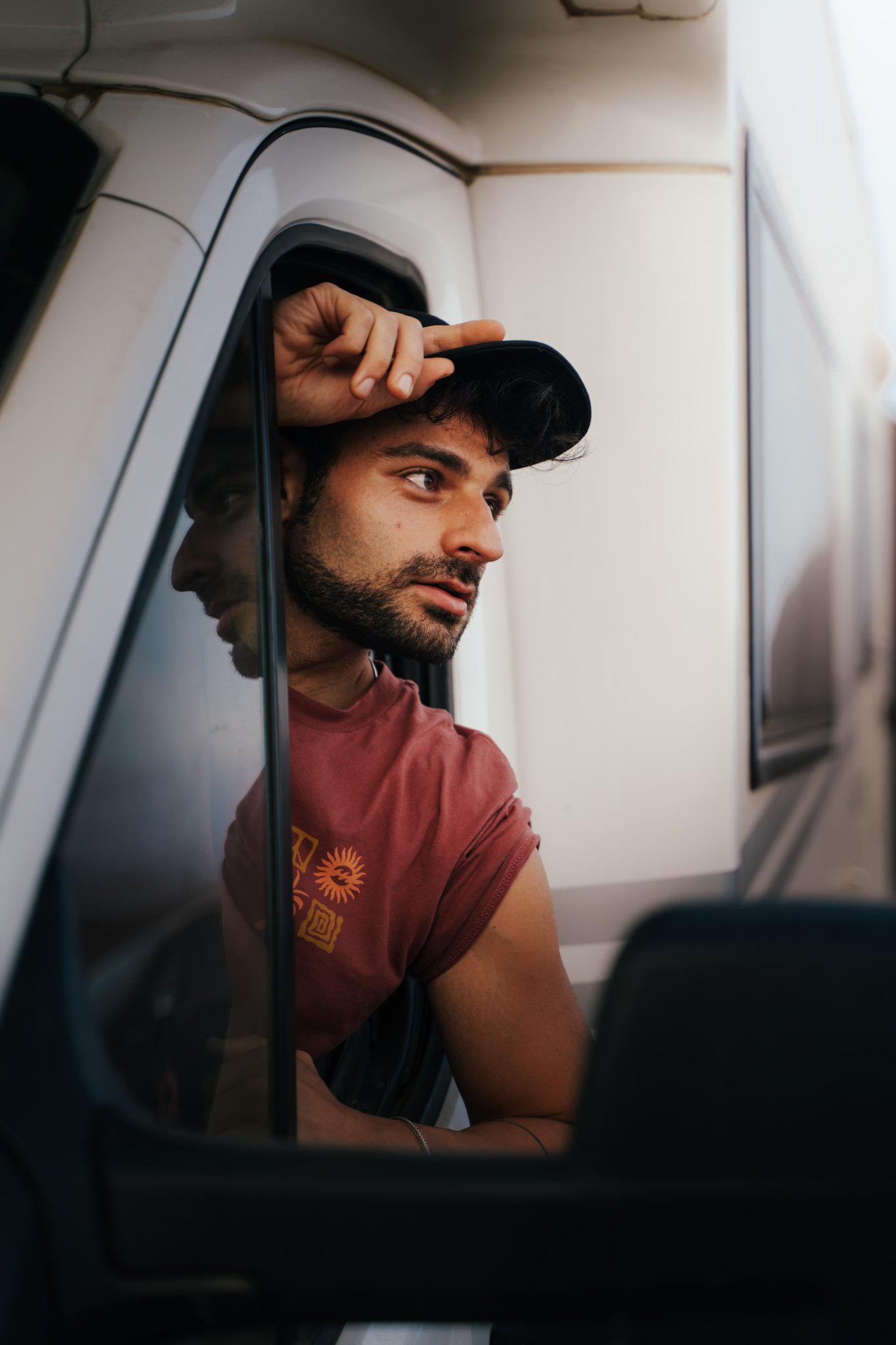 Silhouette of a camera operator filming on a professional set, surrounded by bright studio lights. The scene conveys focus and creative energy.