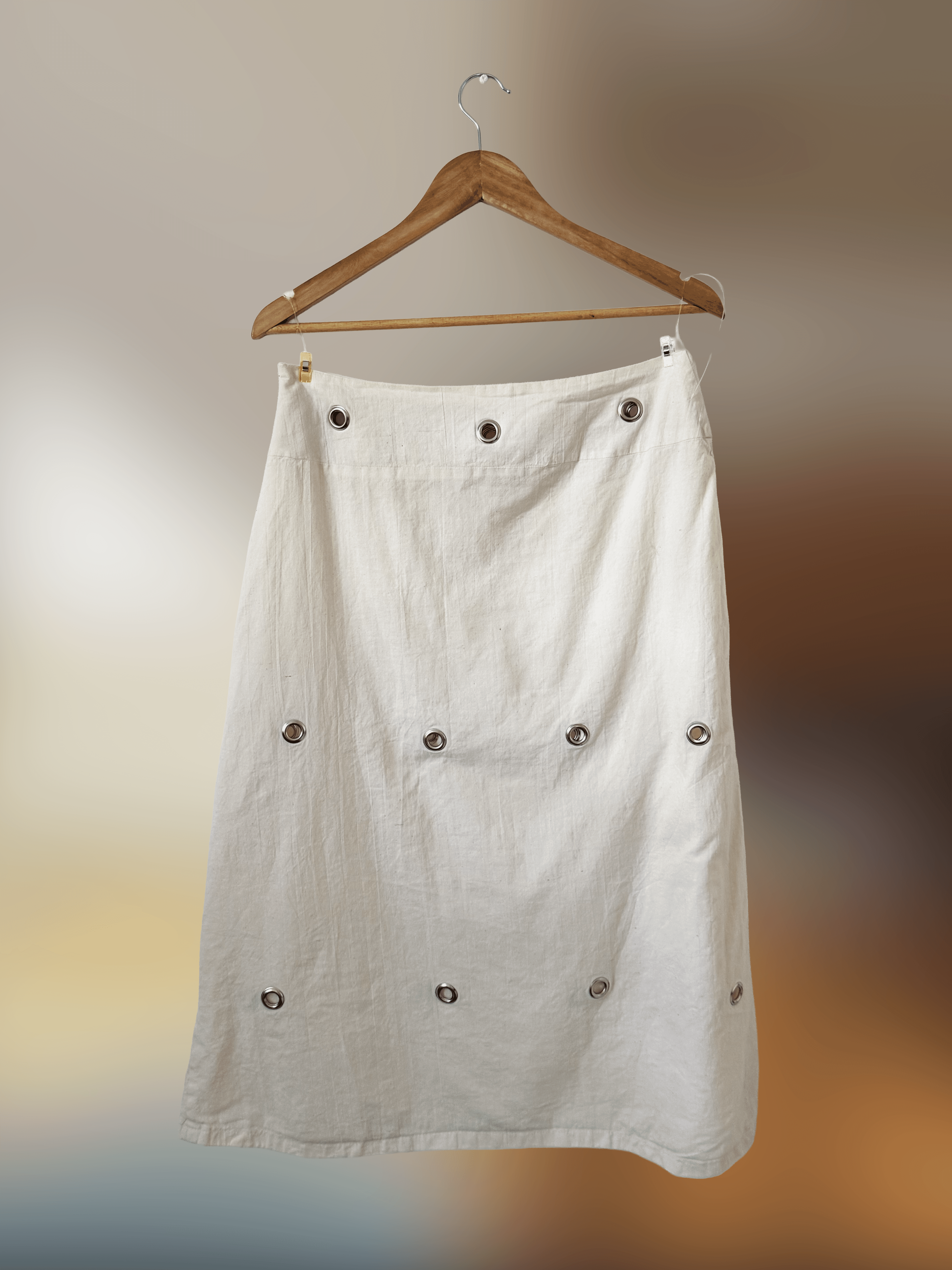 Long skirt in natural cotton with silver grommet detailing