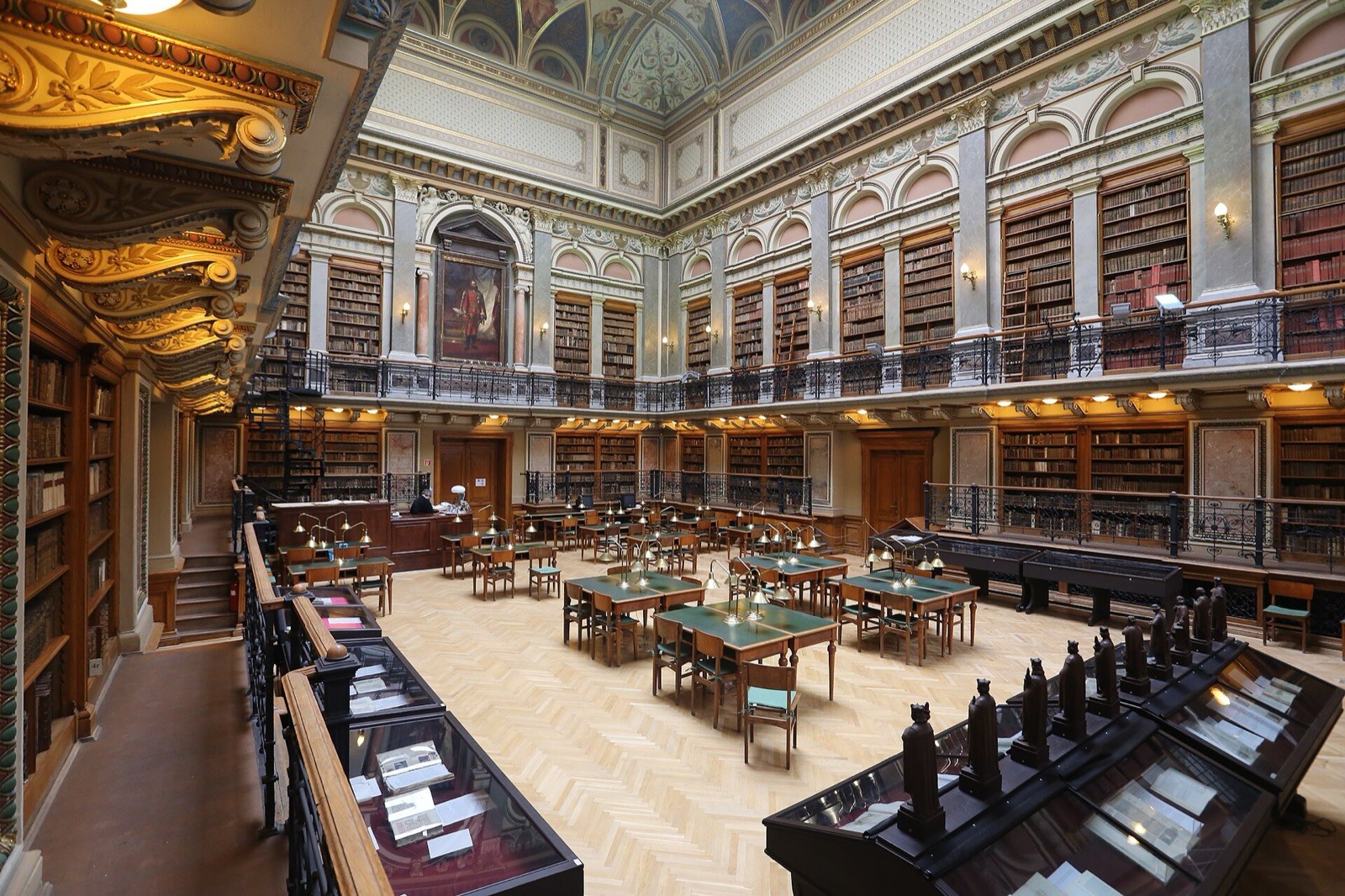 A university library reading room lined with reference volumes.