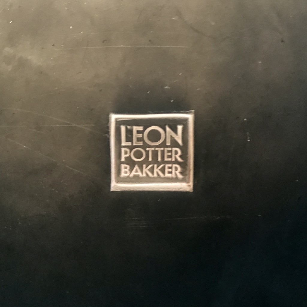 Woman practicing aerial yoga with white hammock