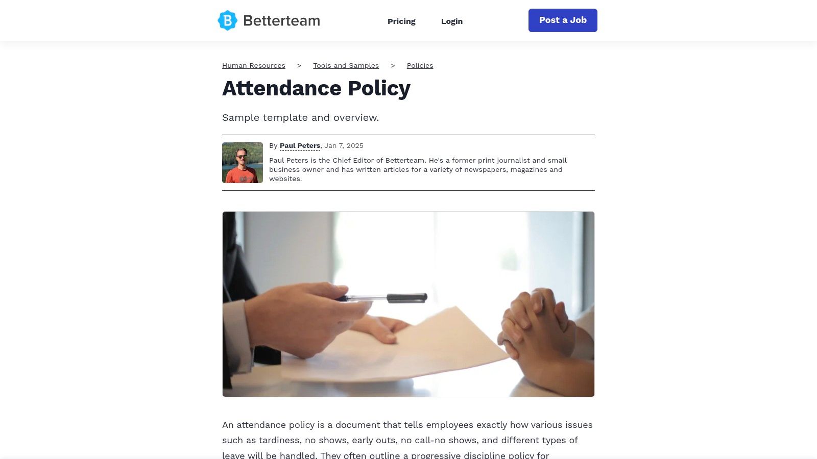 A person signing a document, symbolizing the implementation of a new attendance policy.