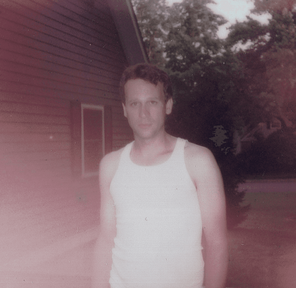 THE COUNT album cover featuring Daniel Bateman in a white tank-top staring blankly at the camera.