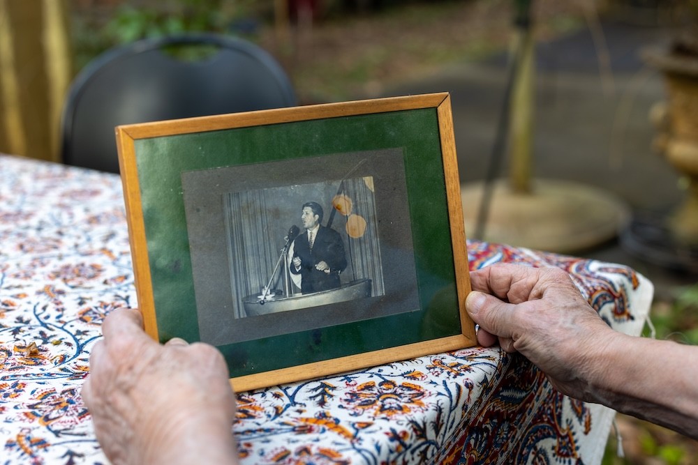 Bubjan with book and speaking to camera