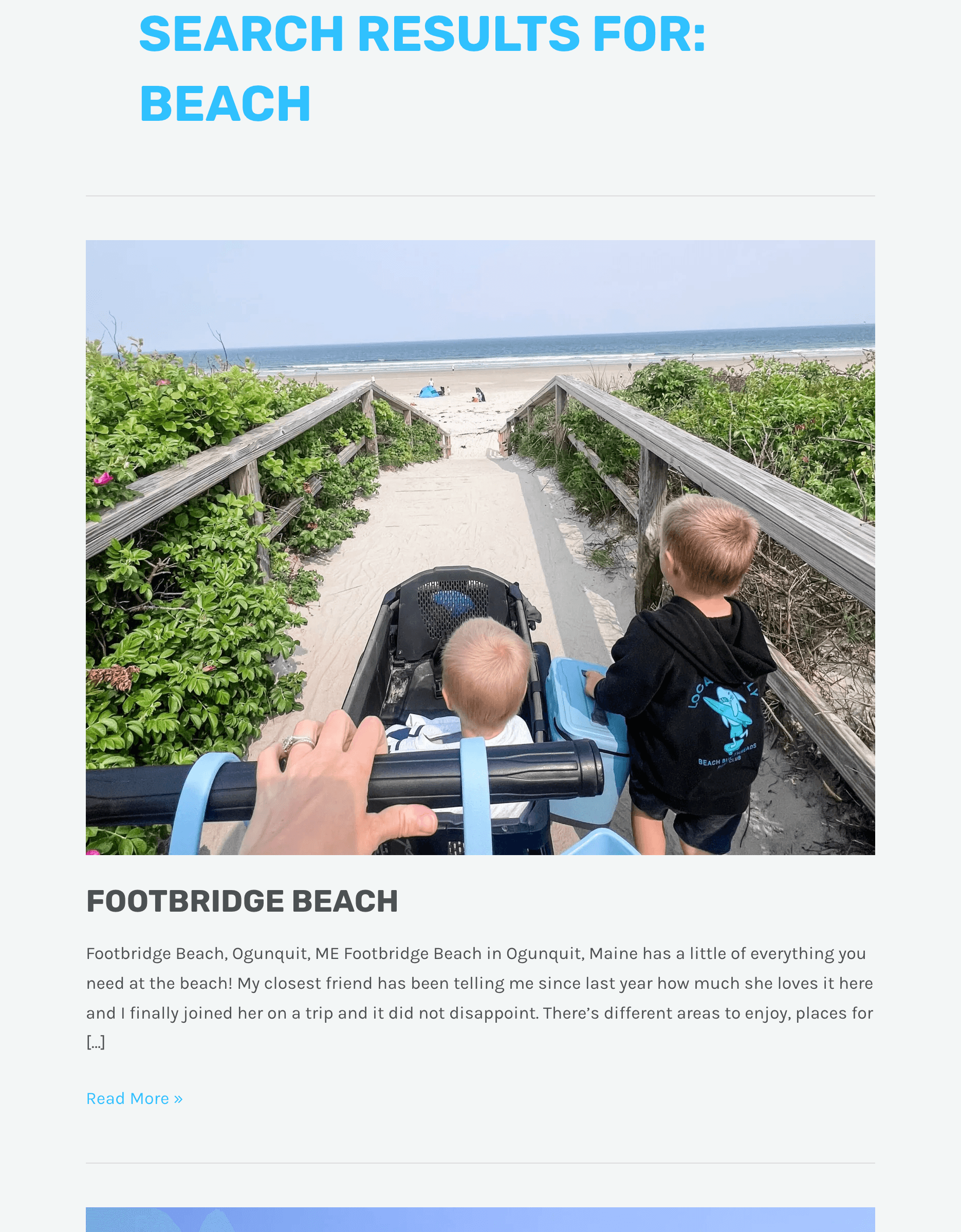 An elephant with large tusks in a lush green landscape.