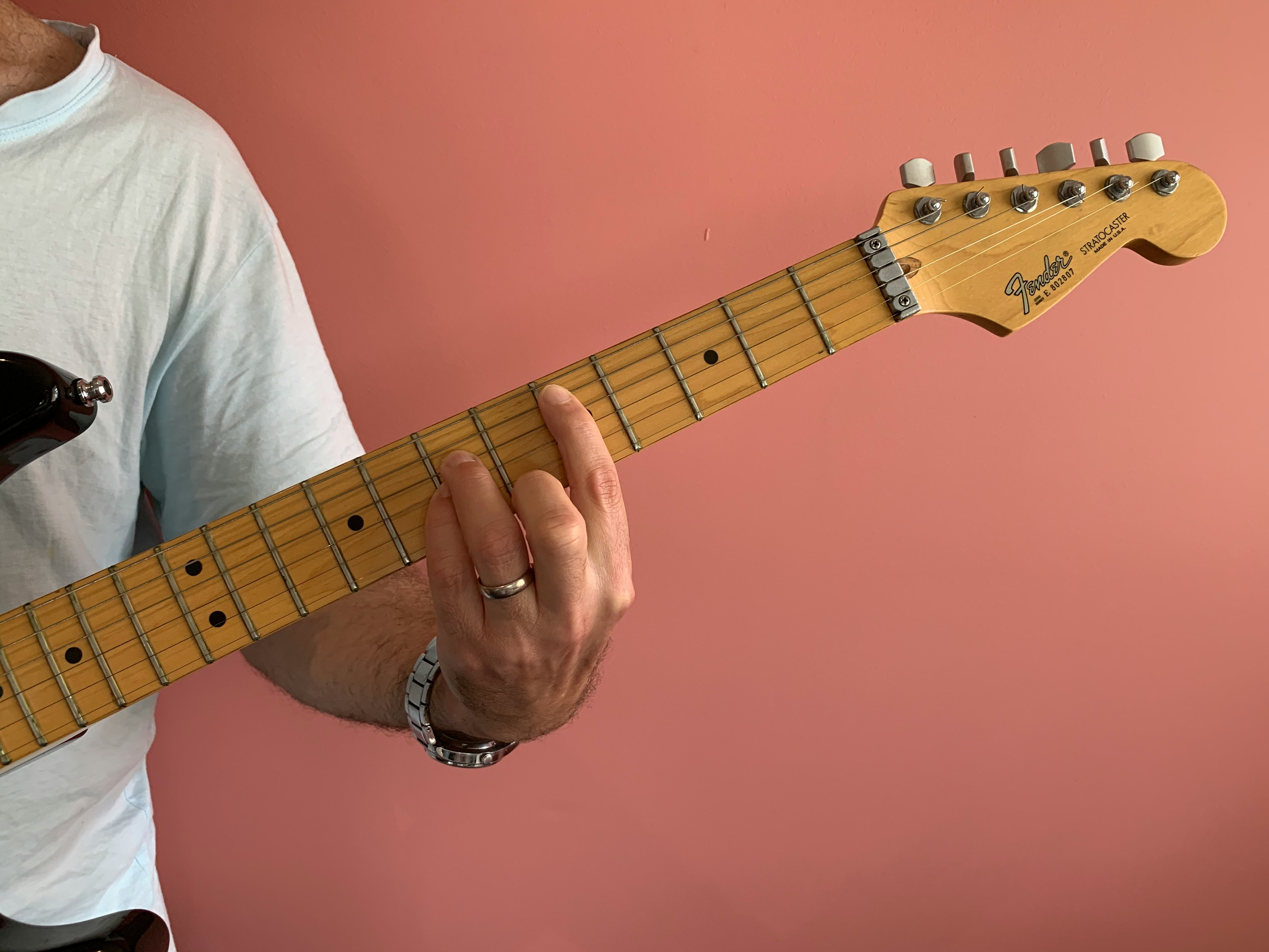 Man fretting a guitar
