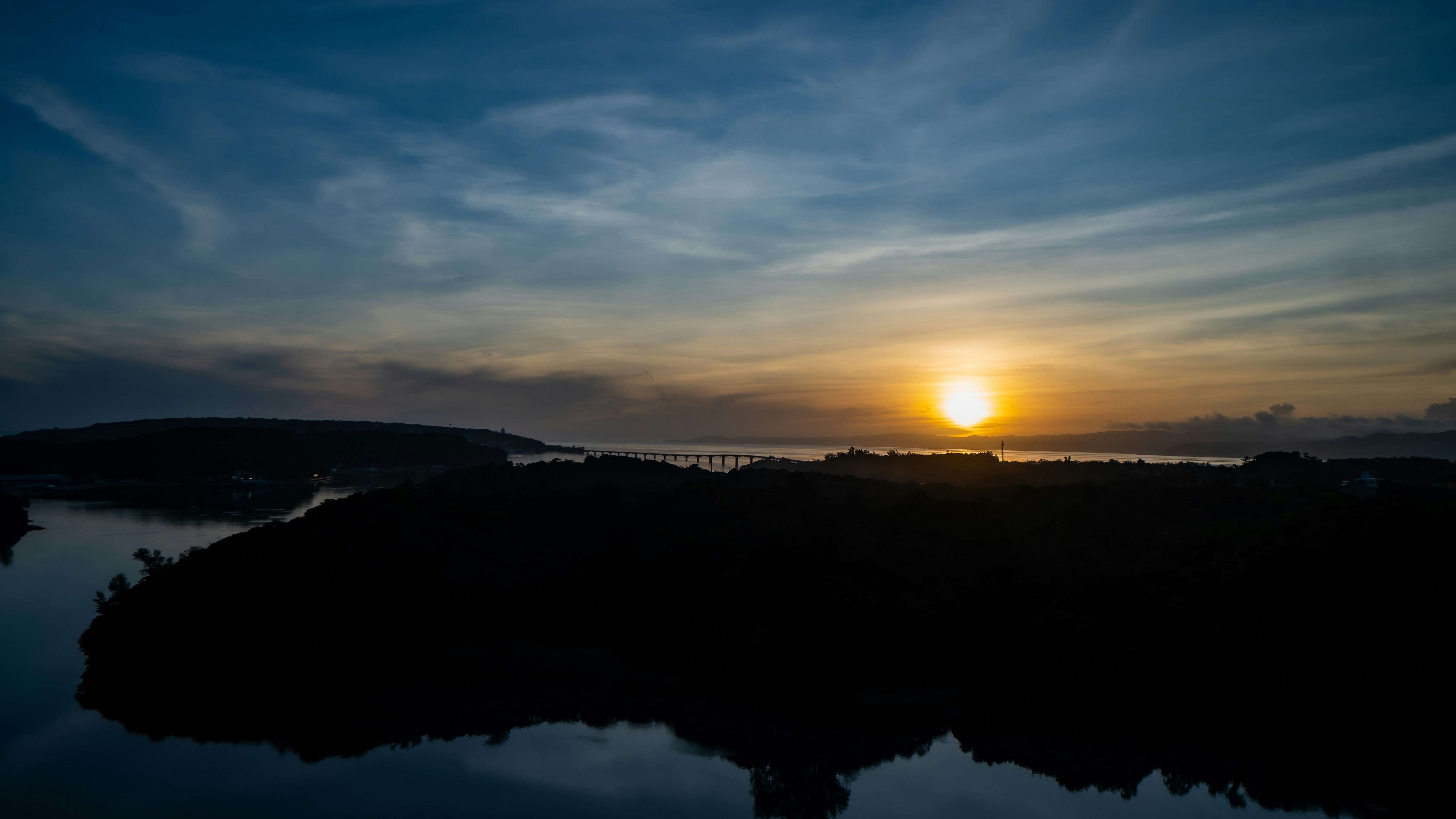 The sun is setting over a body of water