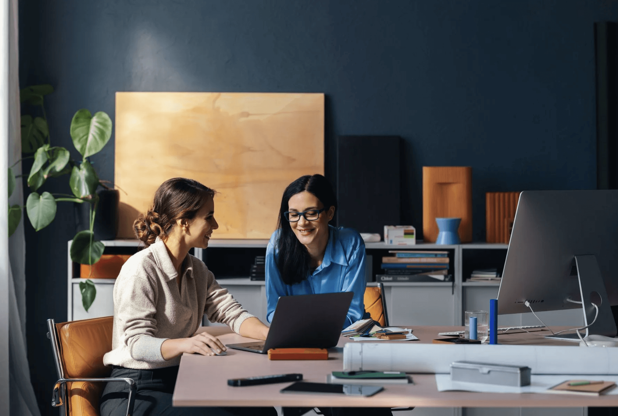 woman holding a phone and man looking at the phone. both are smiling