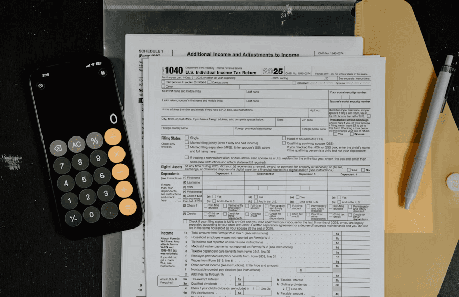 Tax forms and calculator on a desk illustrating tax lawyer cost and tax-document review