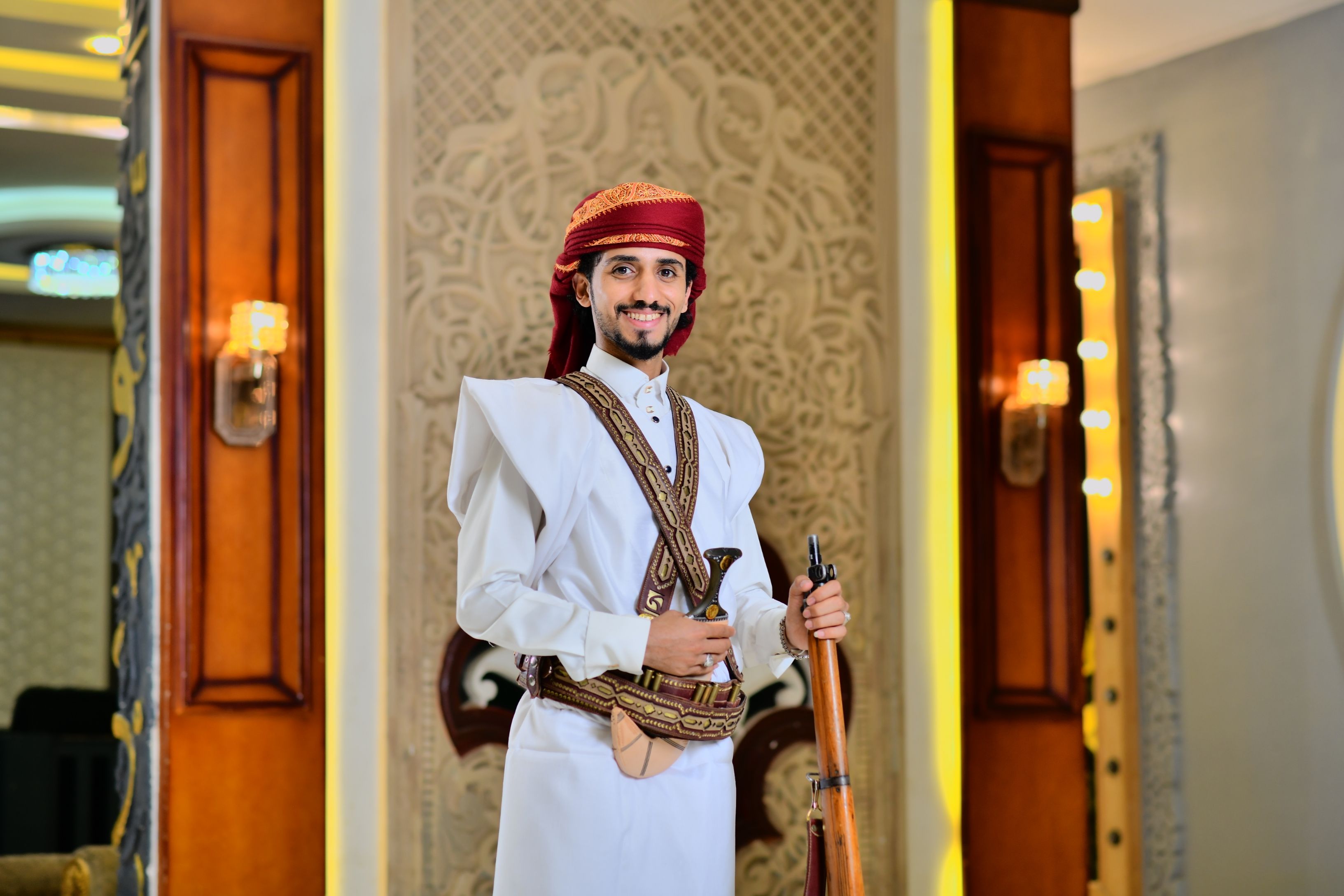 selective focus photo of man standing holding DSLR camera