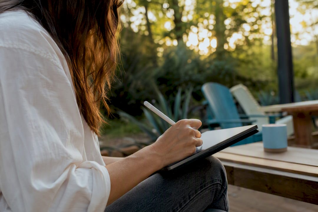Hands writing donor question on tablet