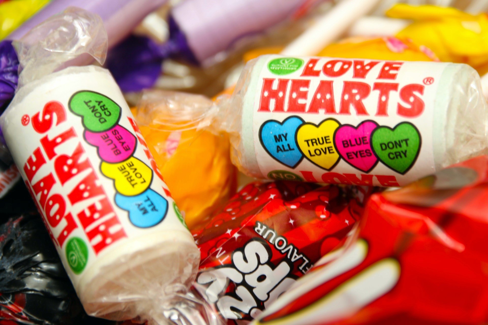 a pile of halloween candy - save at halloween by buying treats in advance