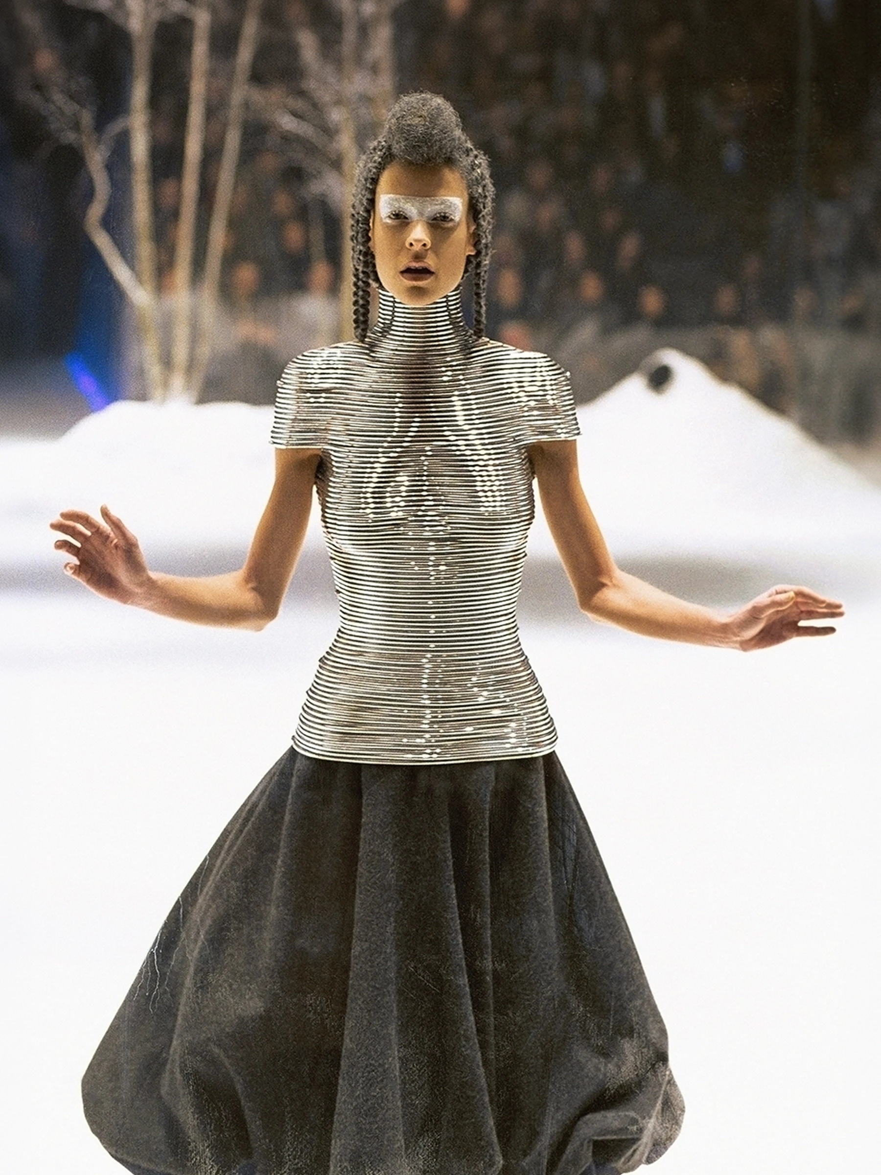 Shaun Leane for Alexander McQueen Coiled Corset made of contoured aluminum rings, worn by a model in a winter snow runway setting