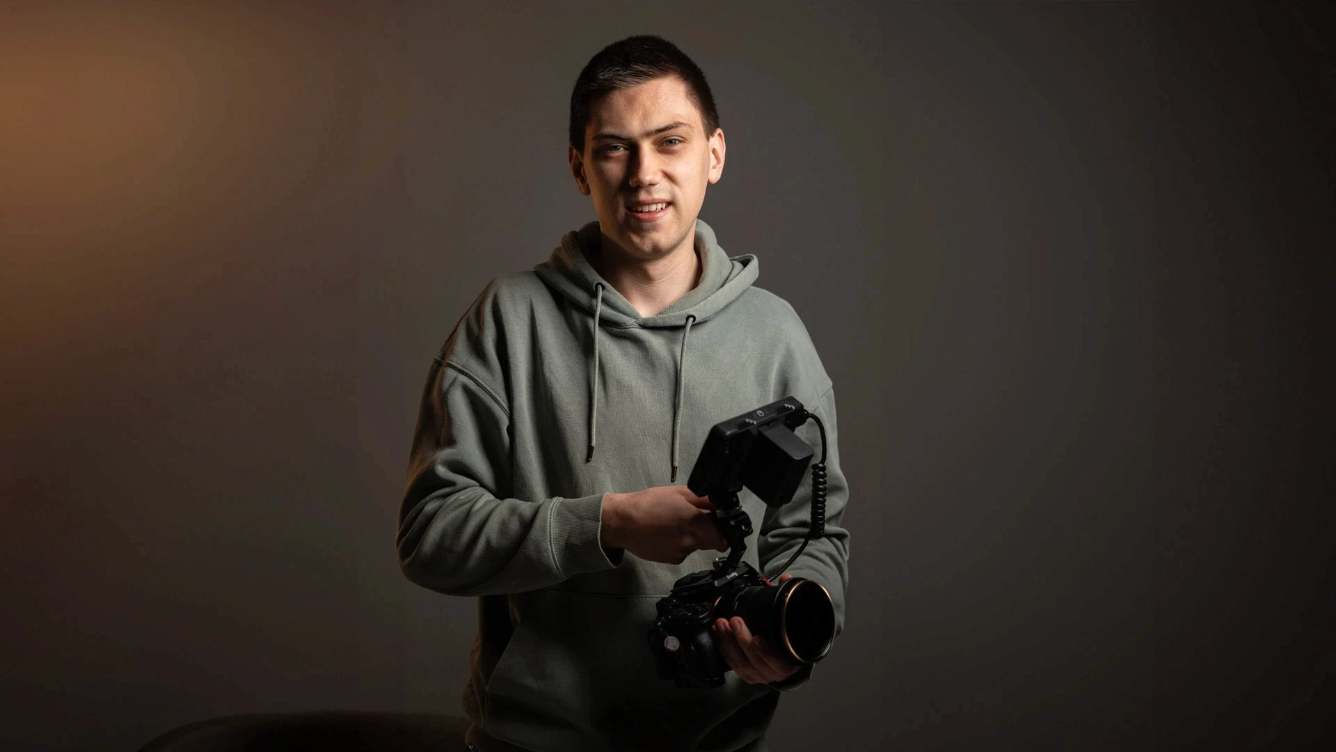 Black and white image of people working at a table with laptops, showing hands gesturing during discussion of digital content displayed on screens, with fabrica® logo in the corner.