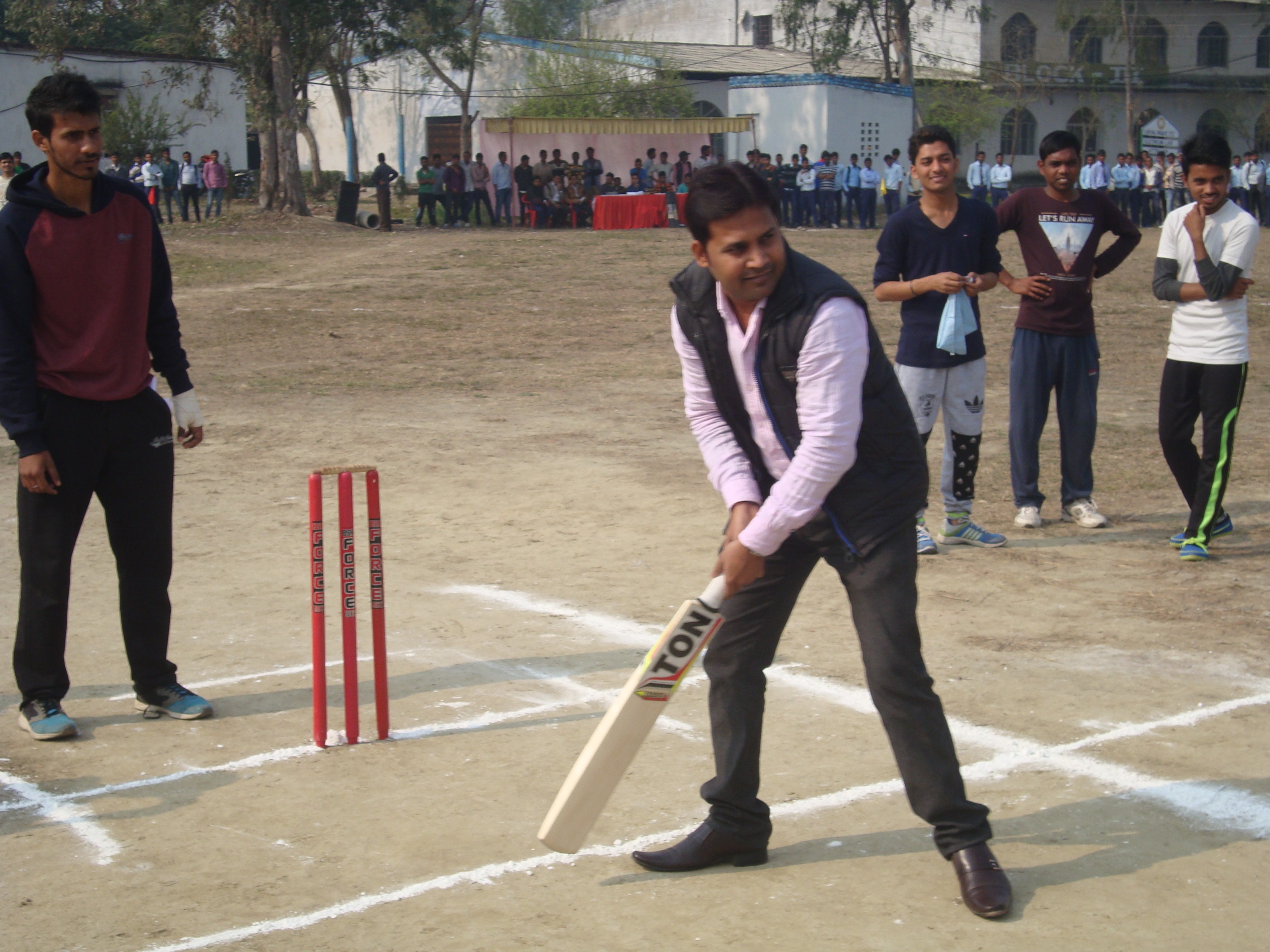 man standing in front of people sitting beside table with laptop computers