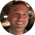 woman in black crew neck t-shirt wearing brown framed eyeglasses standing on rocky shore during