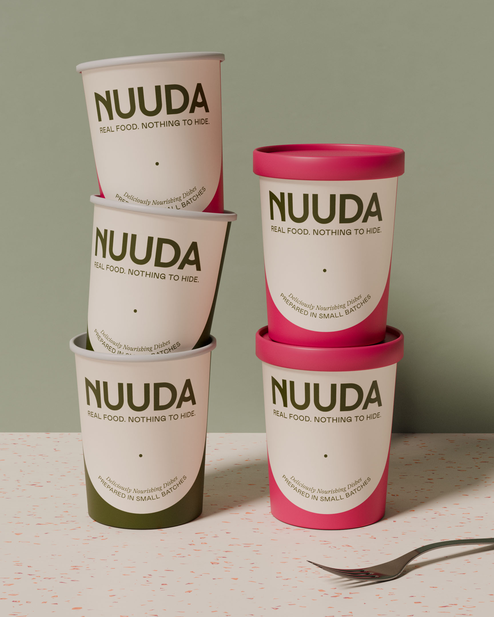 Five Nuuda meal pots with olive green and raspberry pink lids stacked in a playful arrangement against a sage green backdrop