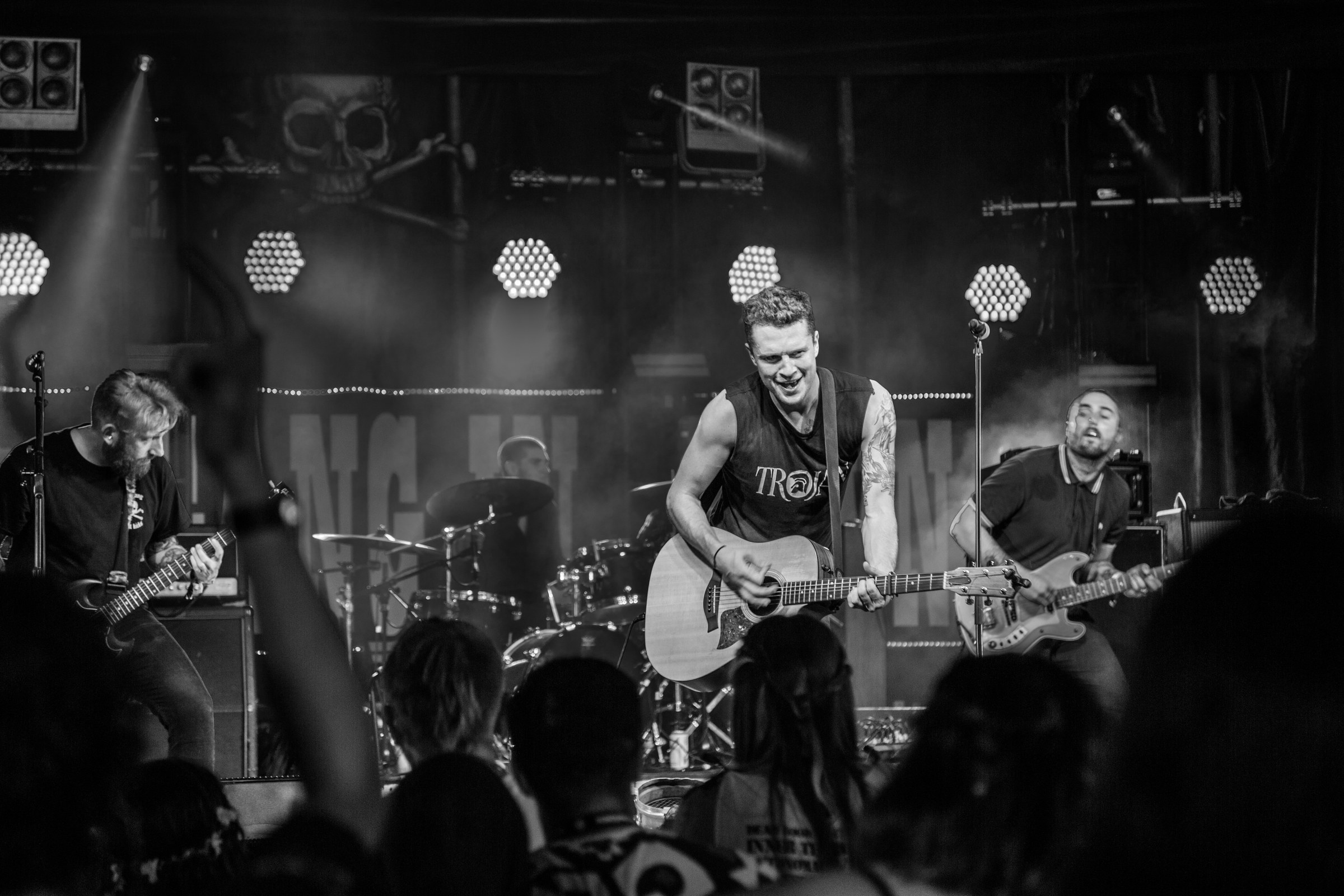 EVENTS · The band on stage, in black and white.