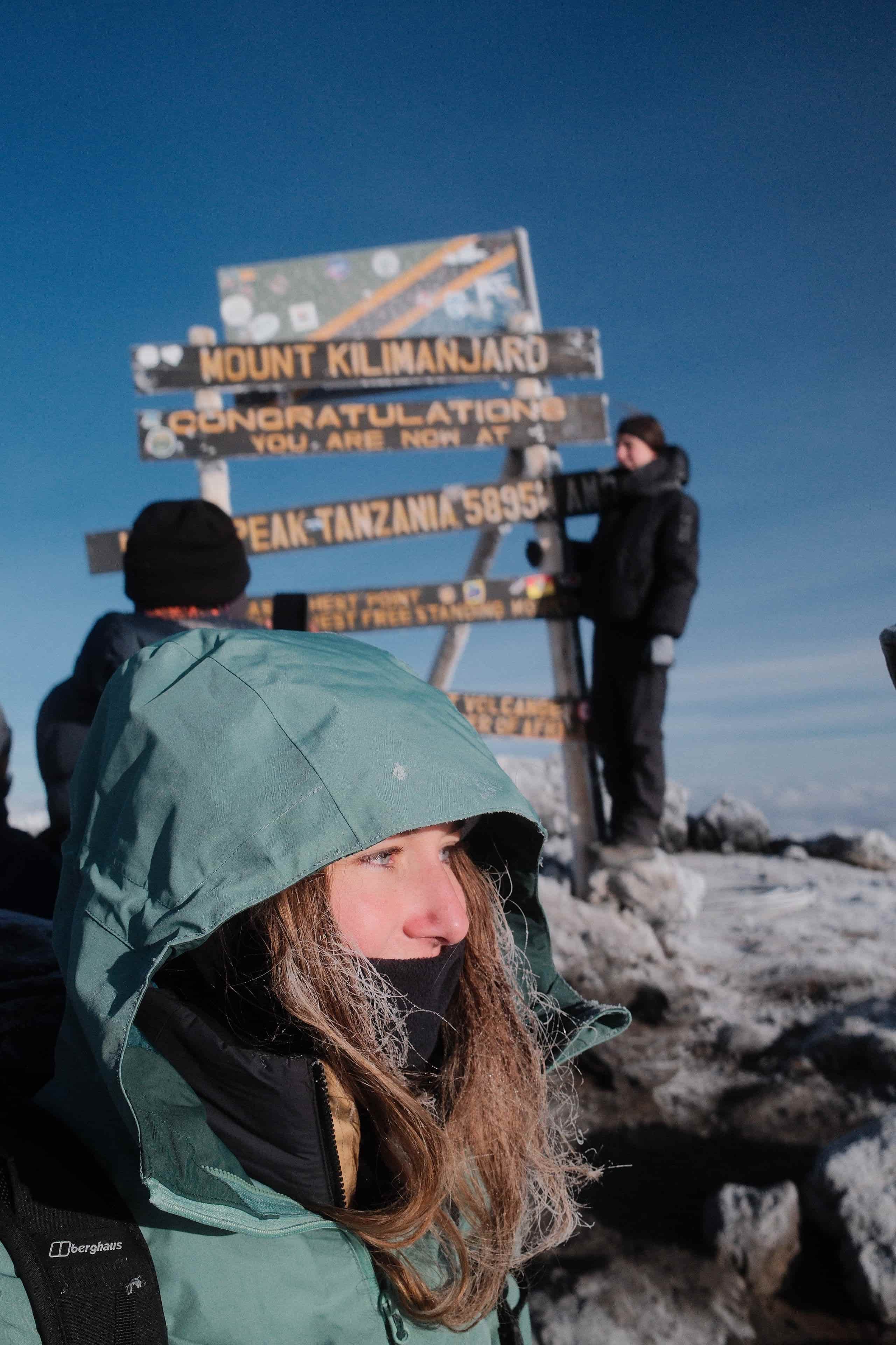 A Legend climber in full summit kit including down jacket and balaclava during the cold pre-dawn push to Uhuru Peak.