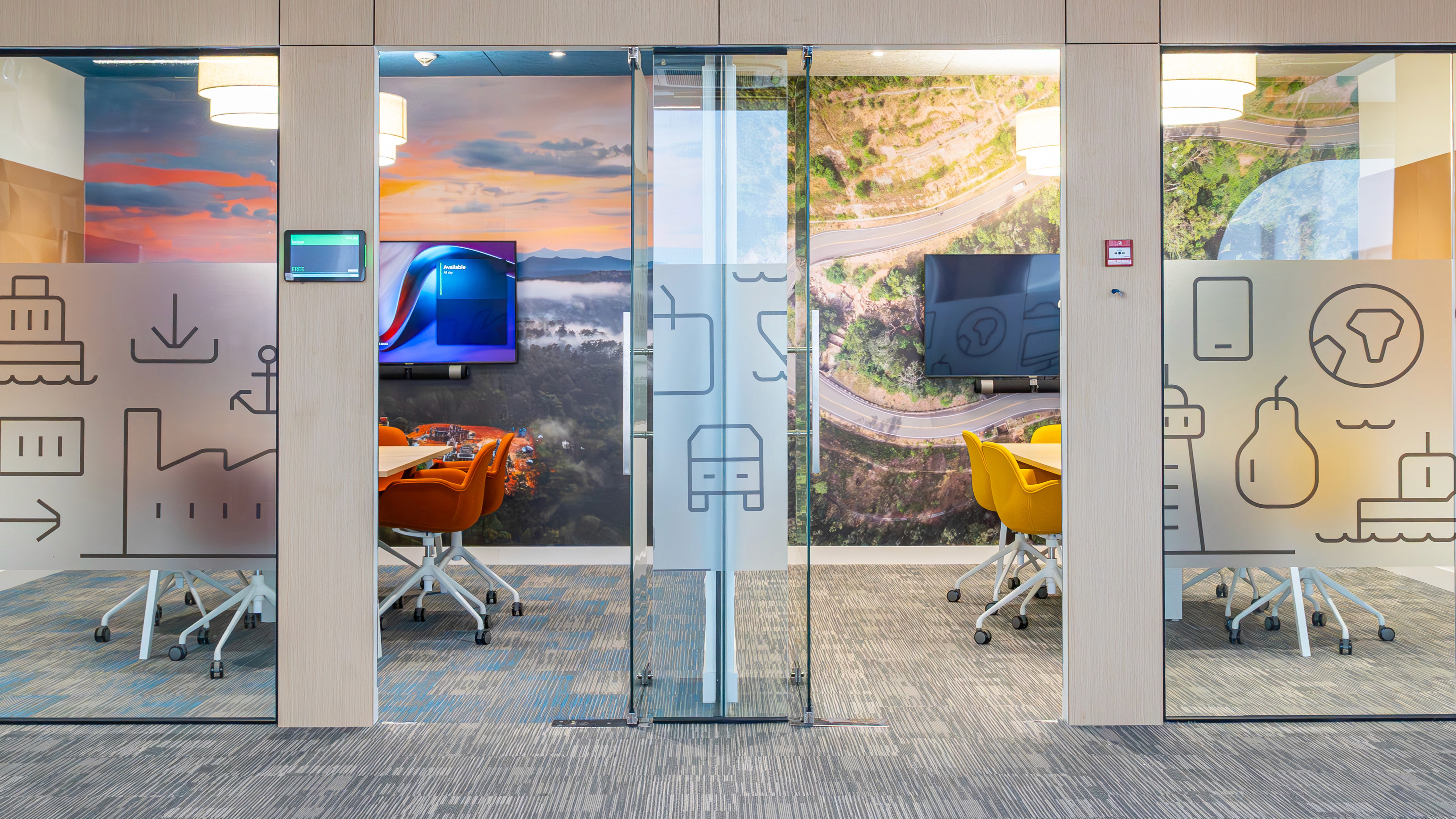 Meeting room with full-height glazing, local landscape graphics, and integrated AV supporting brand narrative and collaboration