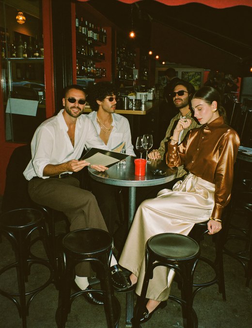 Four friends at a bar table