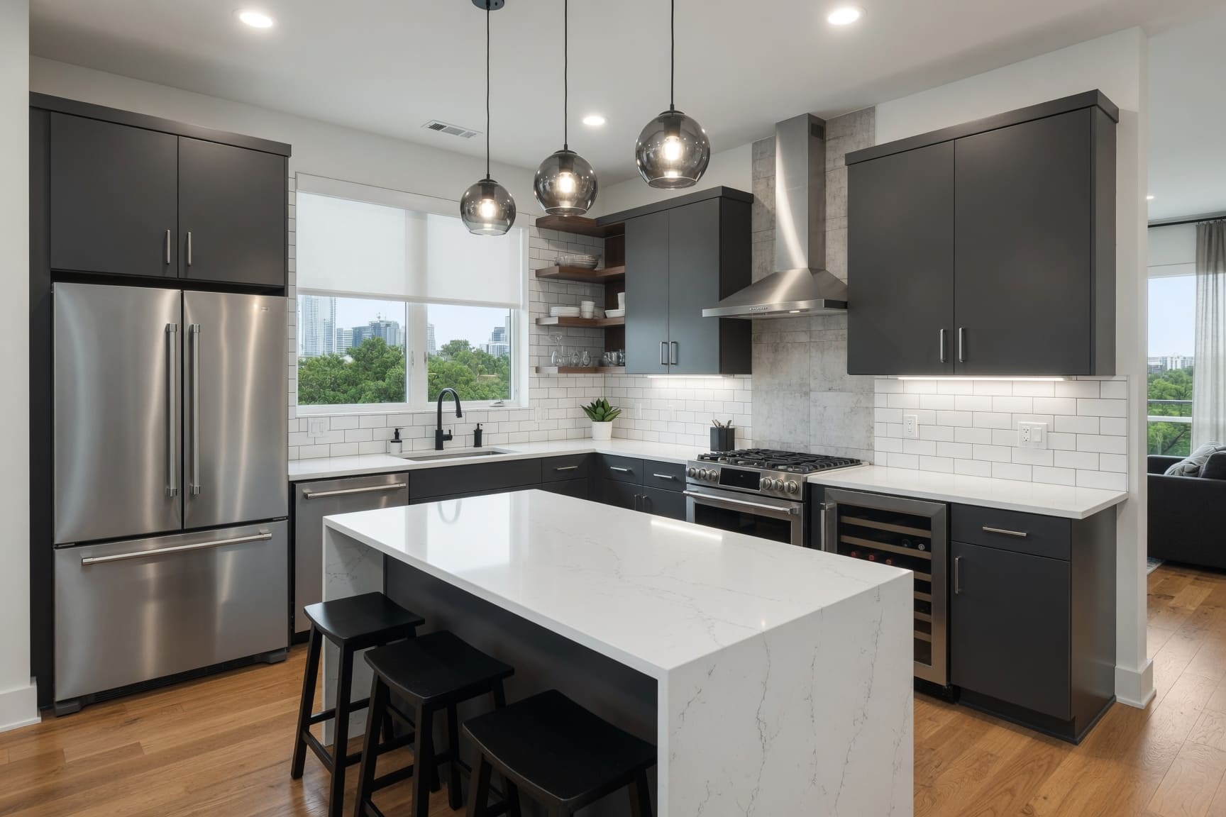 Kitchen with dark cabinetry, marble island, and city views