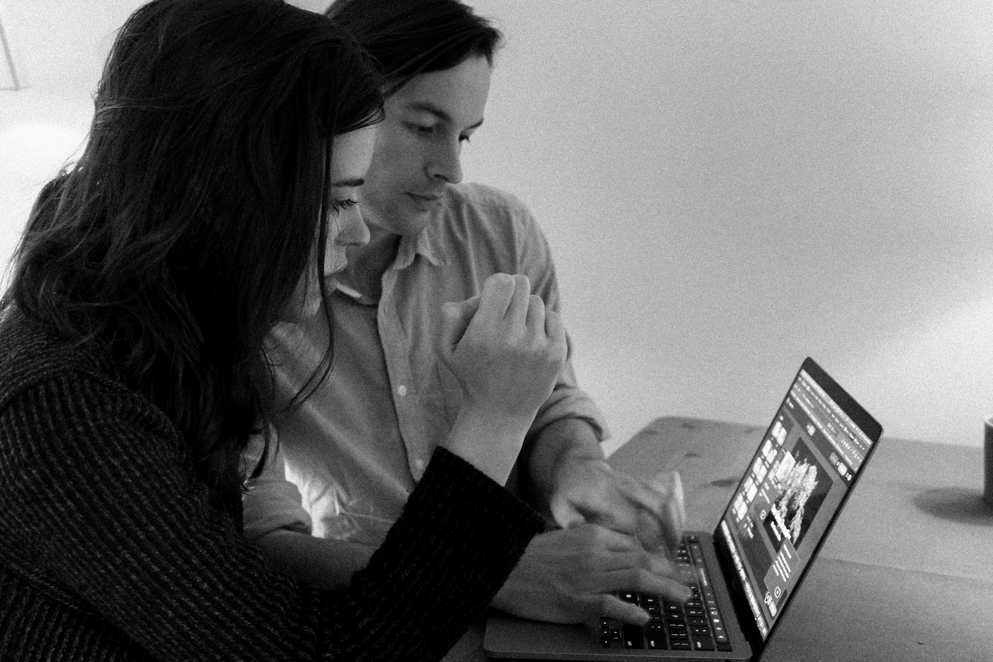 Image of Co-Founders, Julian Maguire and Ella Bugby, working on their computer