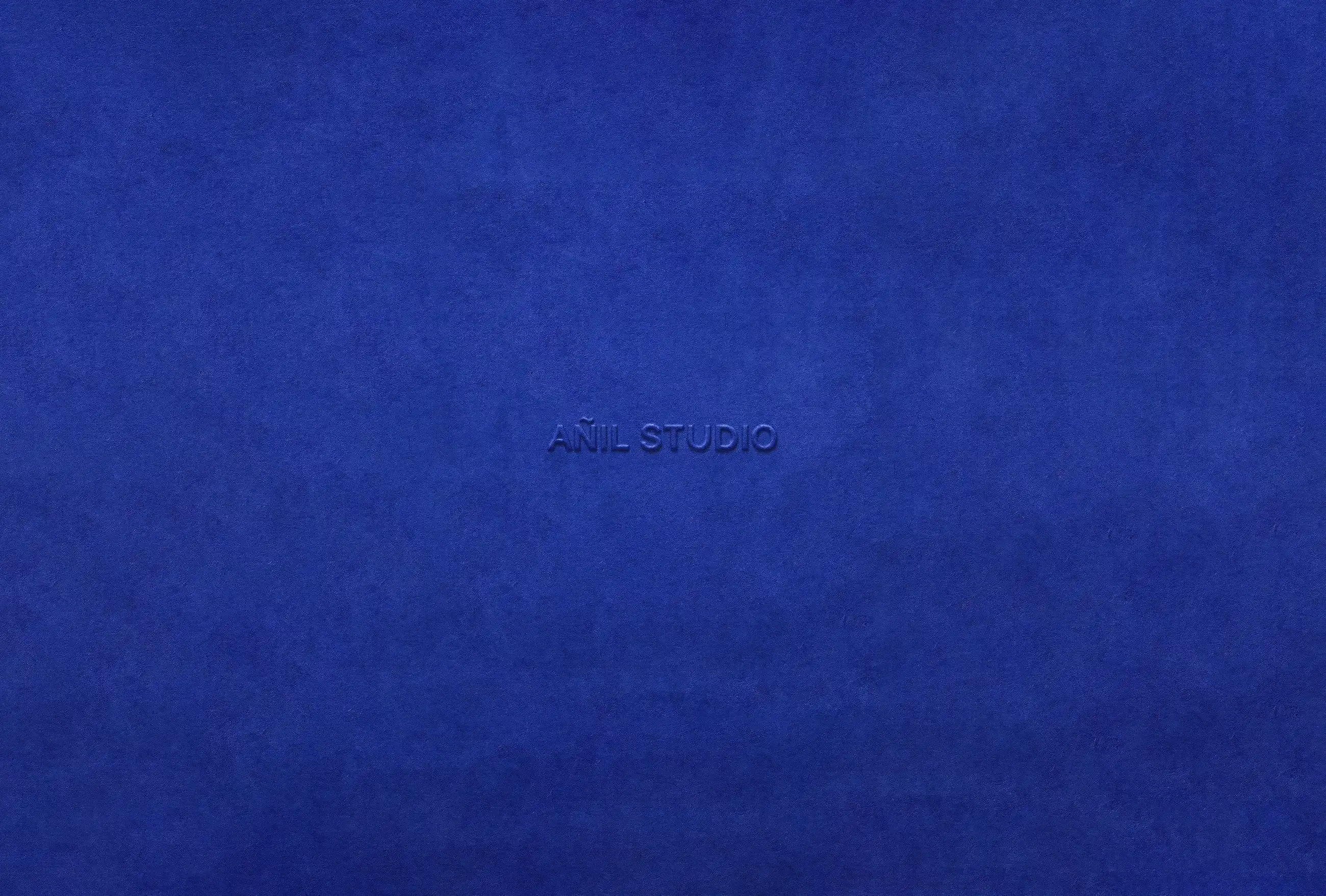 AÑIL STUDIO logo on textured blue background