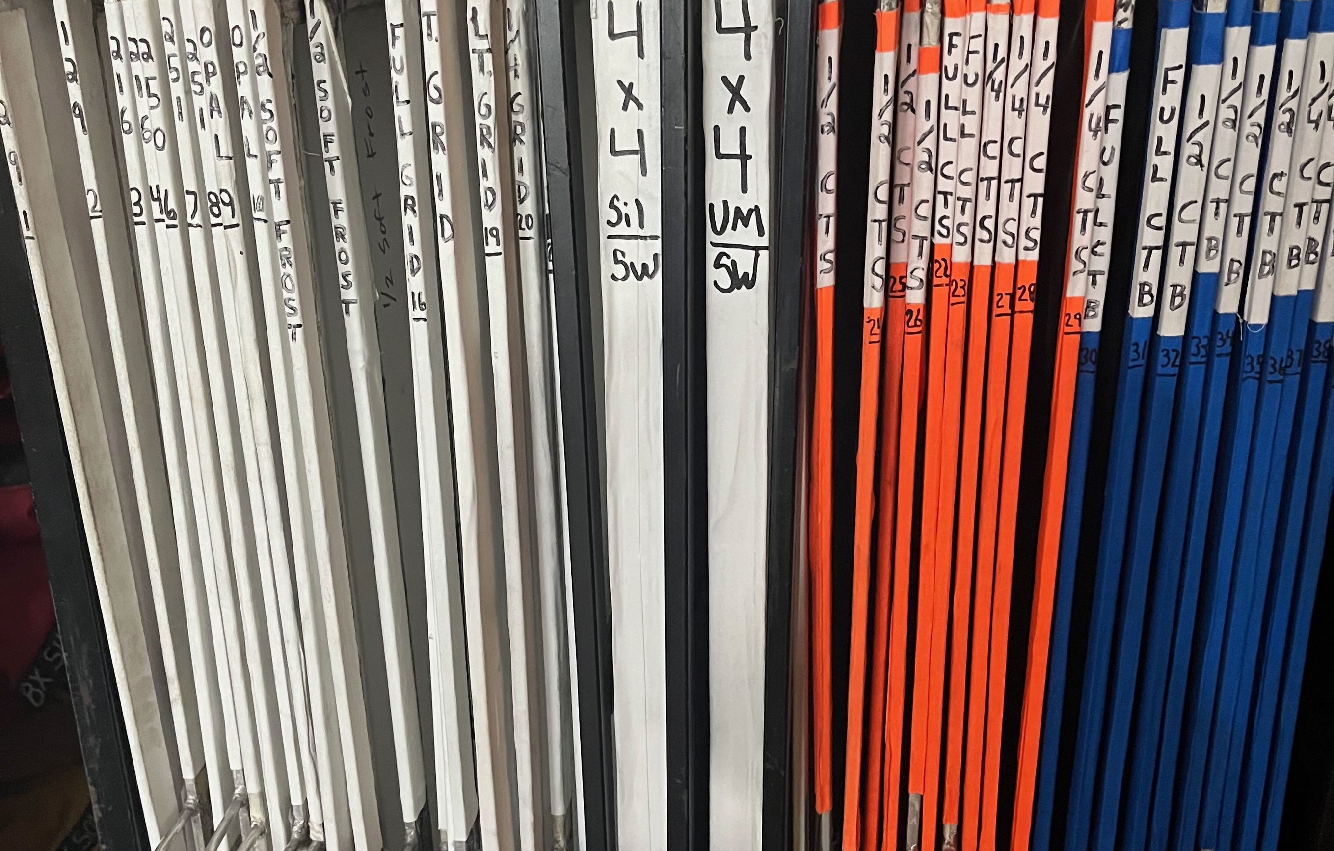 A grip cart holding labeled 4x4 diffusion and color-correction frames stored vertically.