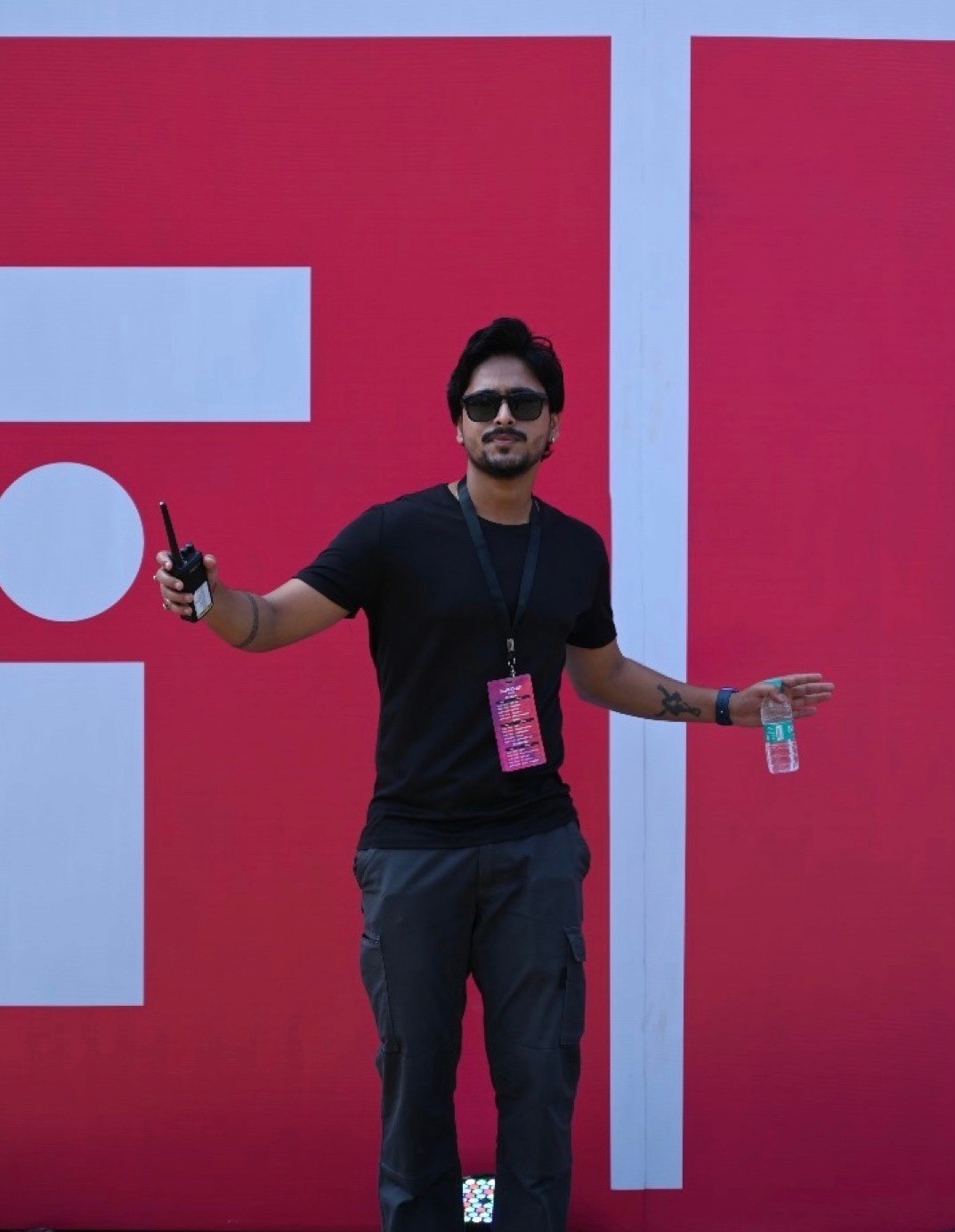 A black and white photo of a man standing in front of a door