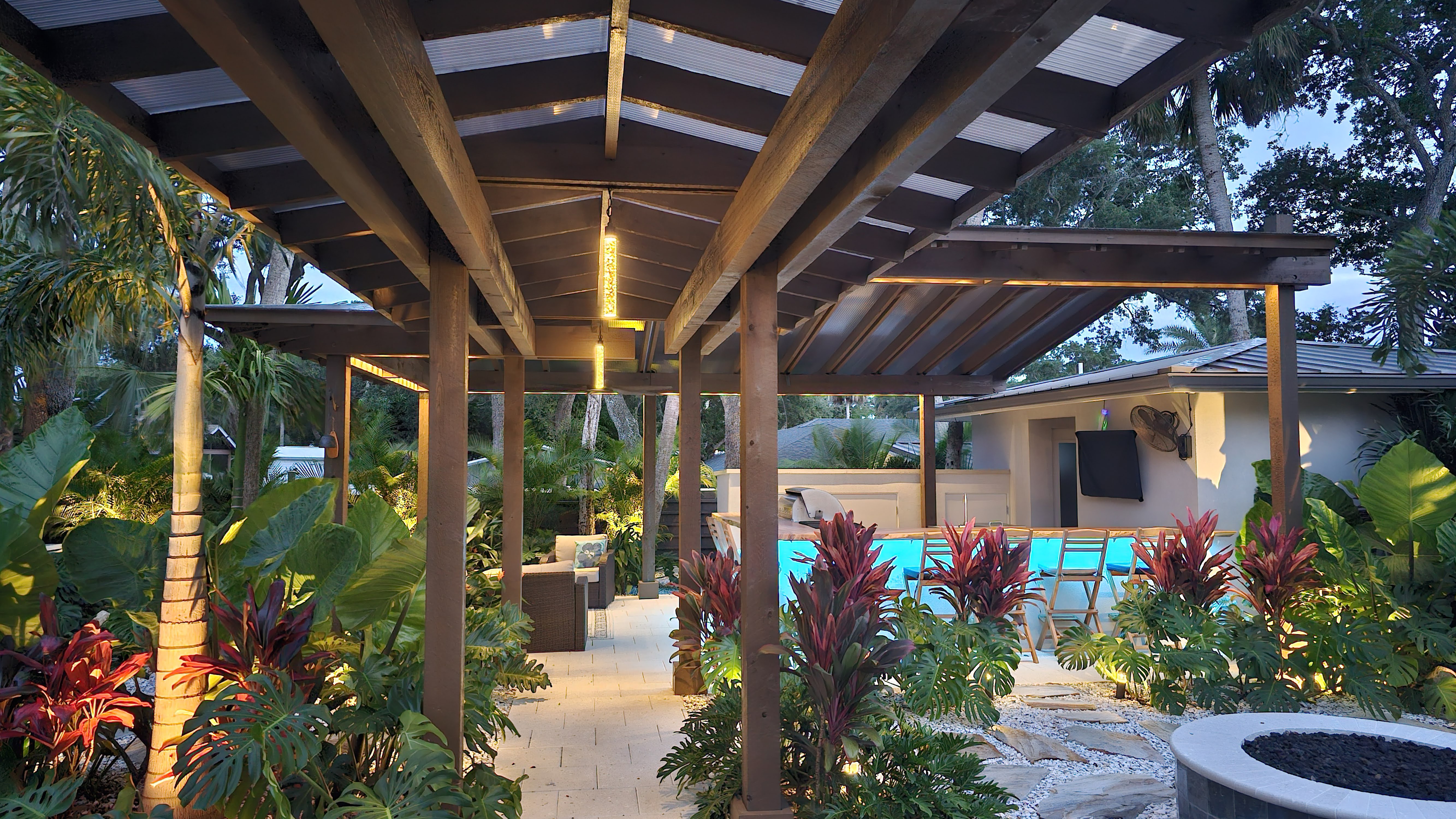 Pergola outdoor living space with integrated ceiling lighting and landscape illumination