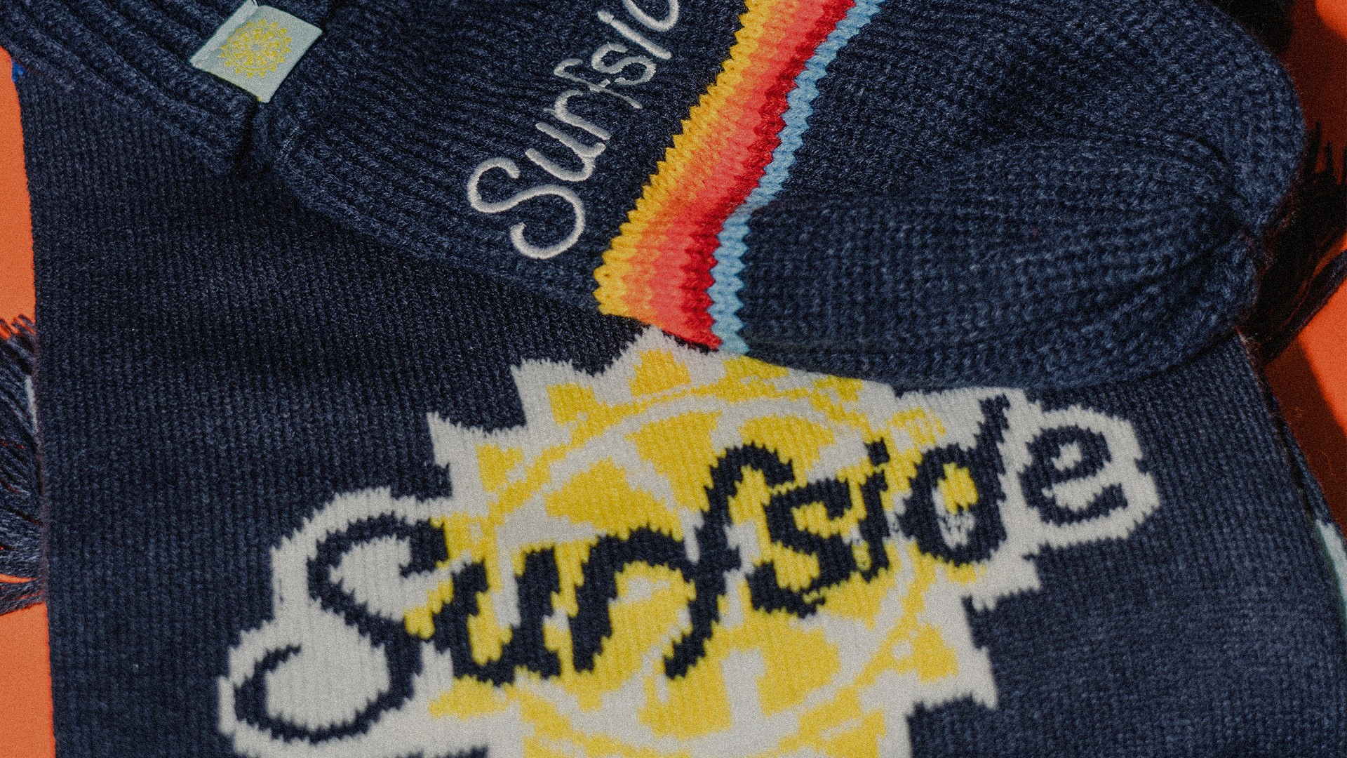 Close up of custom sweater and mittens that say surfside on them.