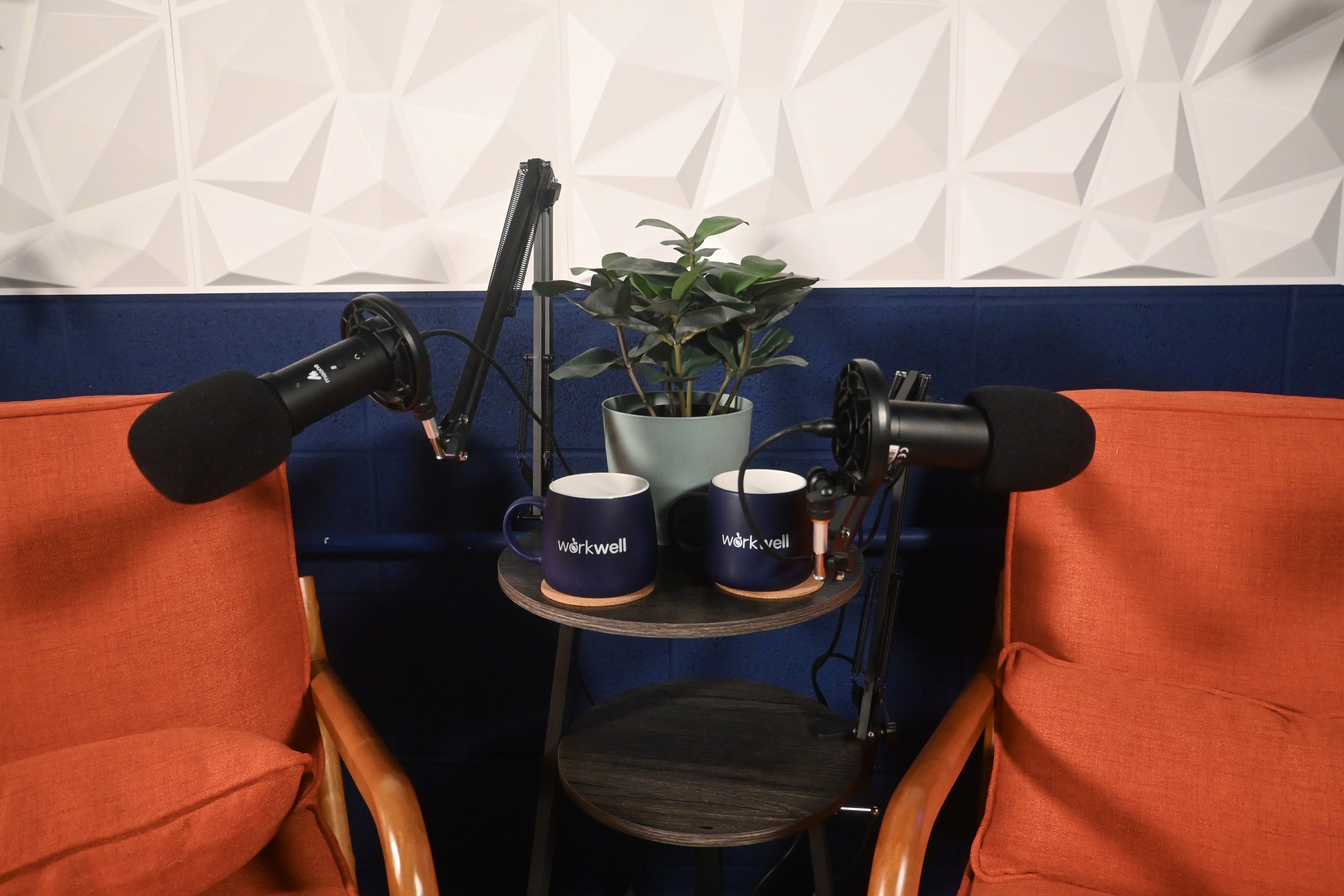 a podcast studio, dimly lit, orange chairs