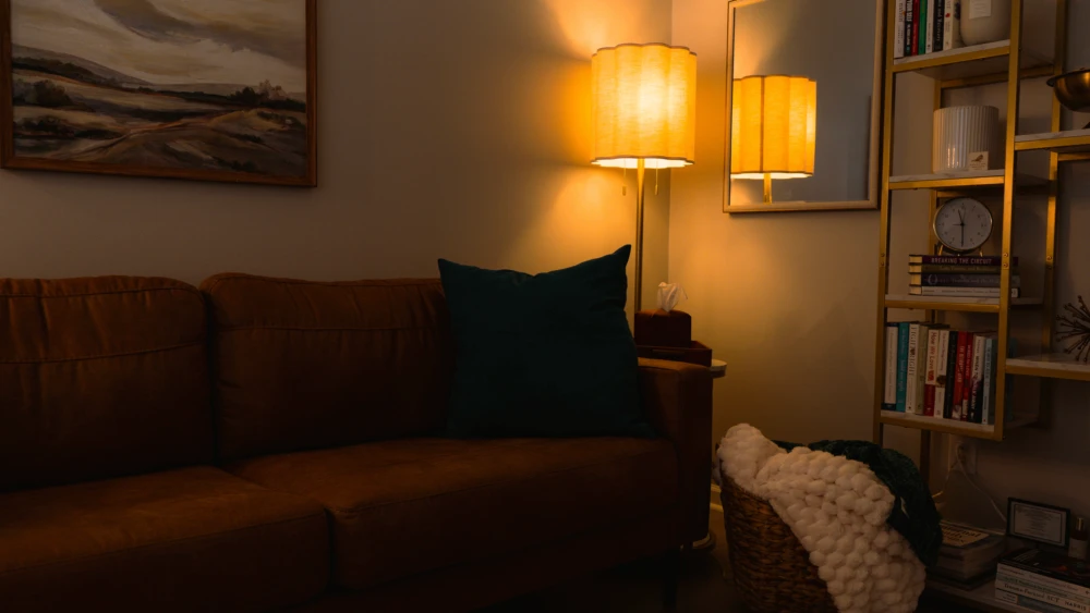 Soft-lit therapy space with cozy seating for clients