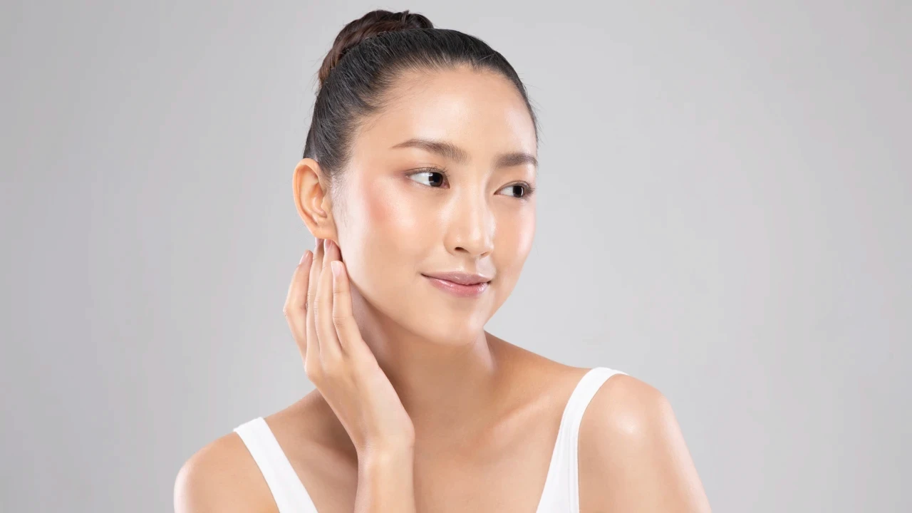 Woman with glowing skin after PDRN skin booster treatment in Singapore