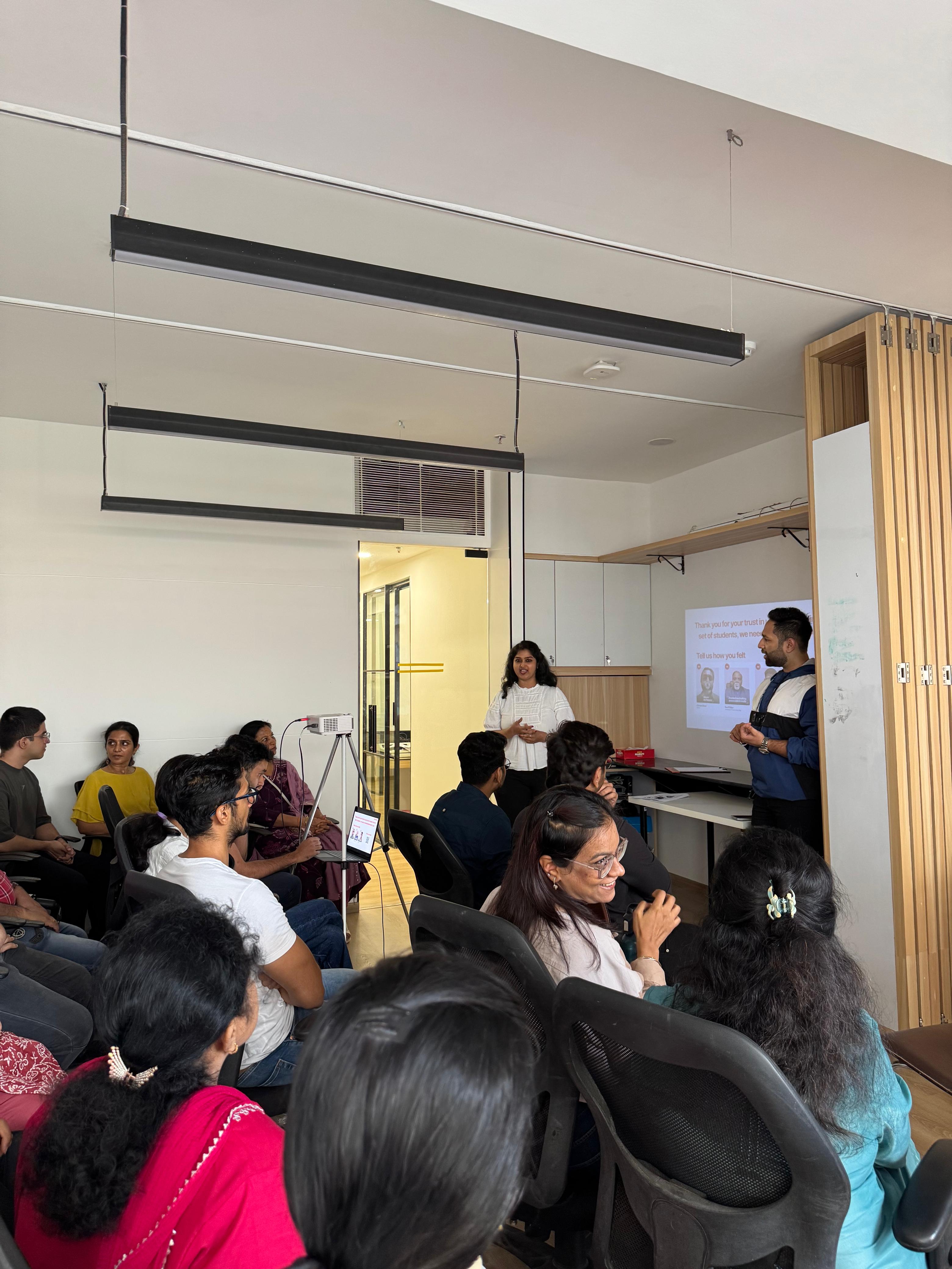 three people sitting in front of table laughing together