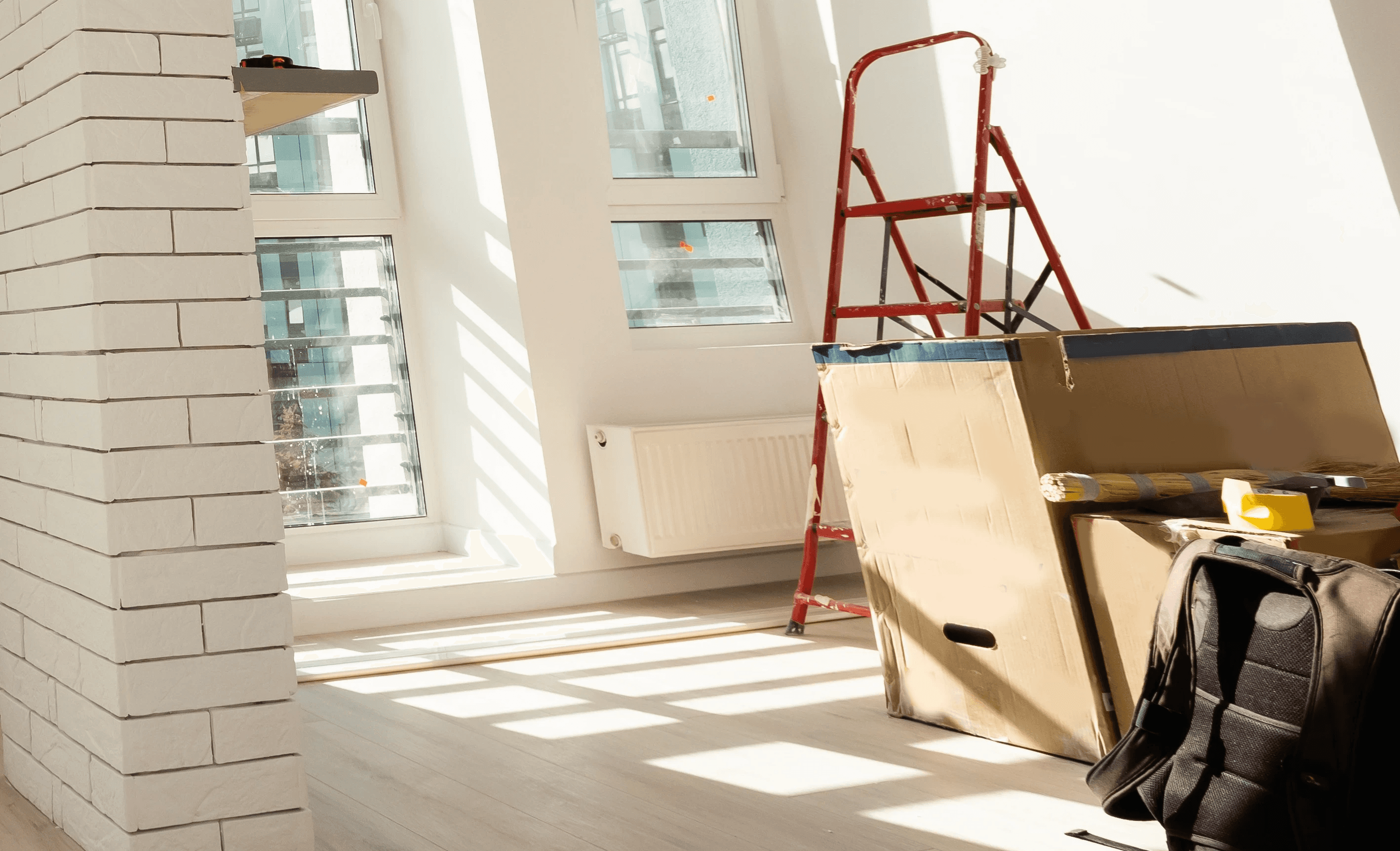 Close-up of a dark green leaf showing its textured surface and central vein against a muted background.